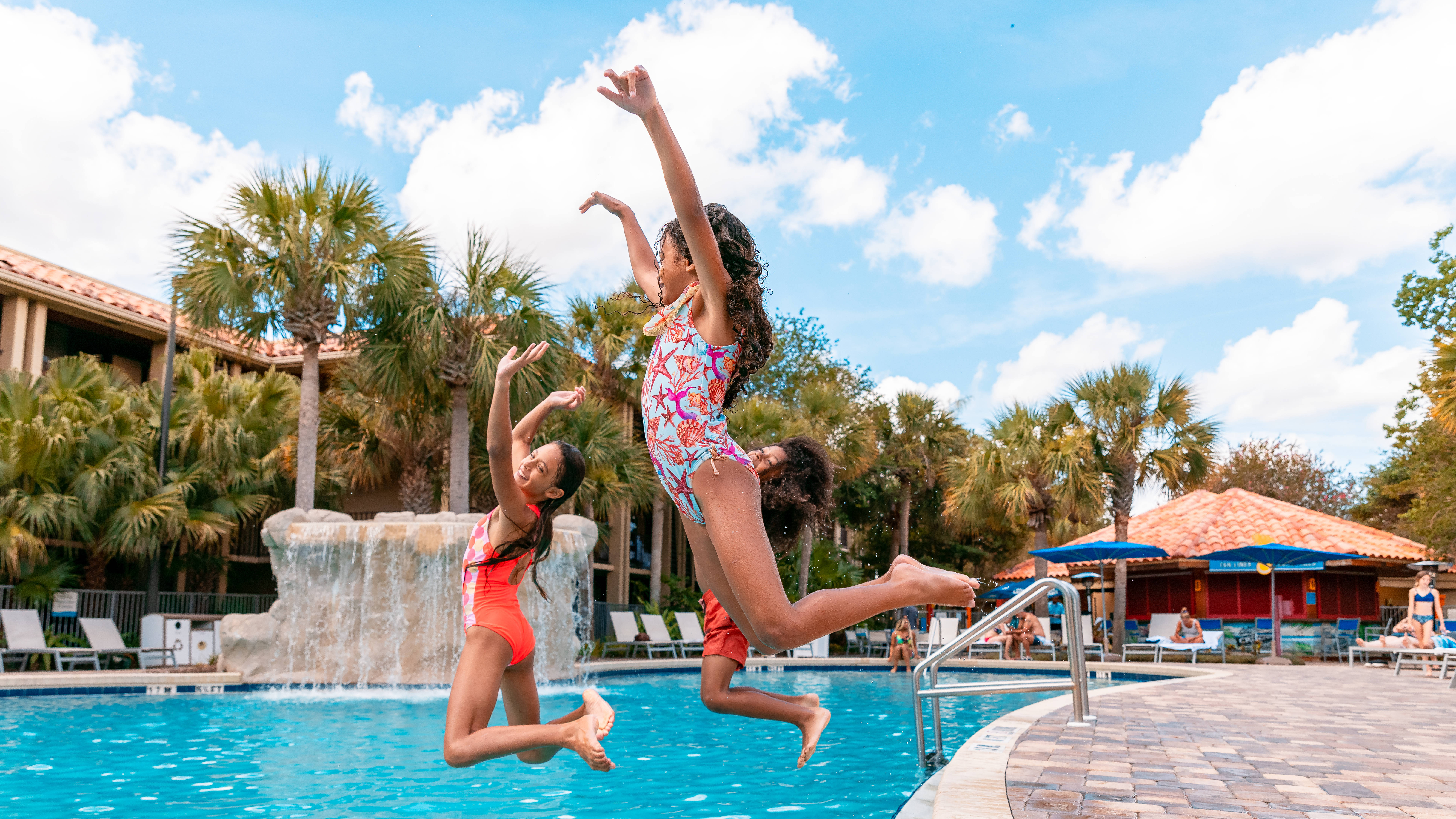 Kids jumping into the pool at the hotel