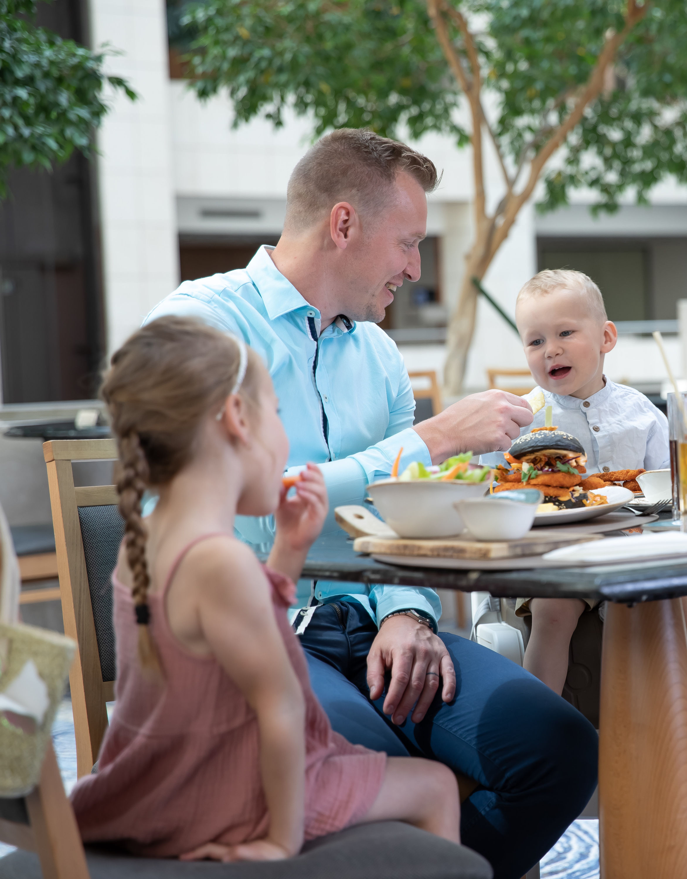 Family Dining on a Terrace at Cafe and Bistro