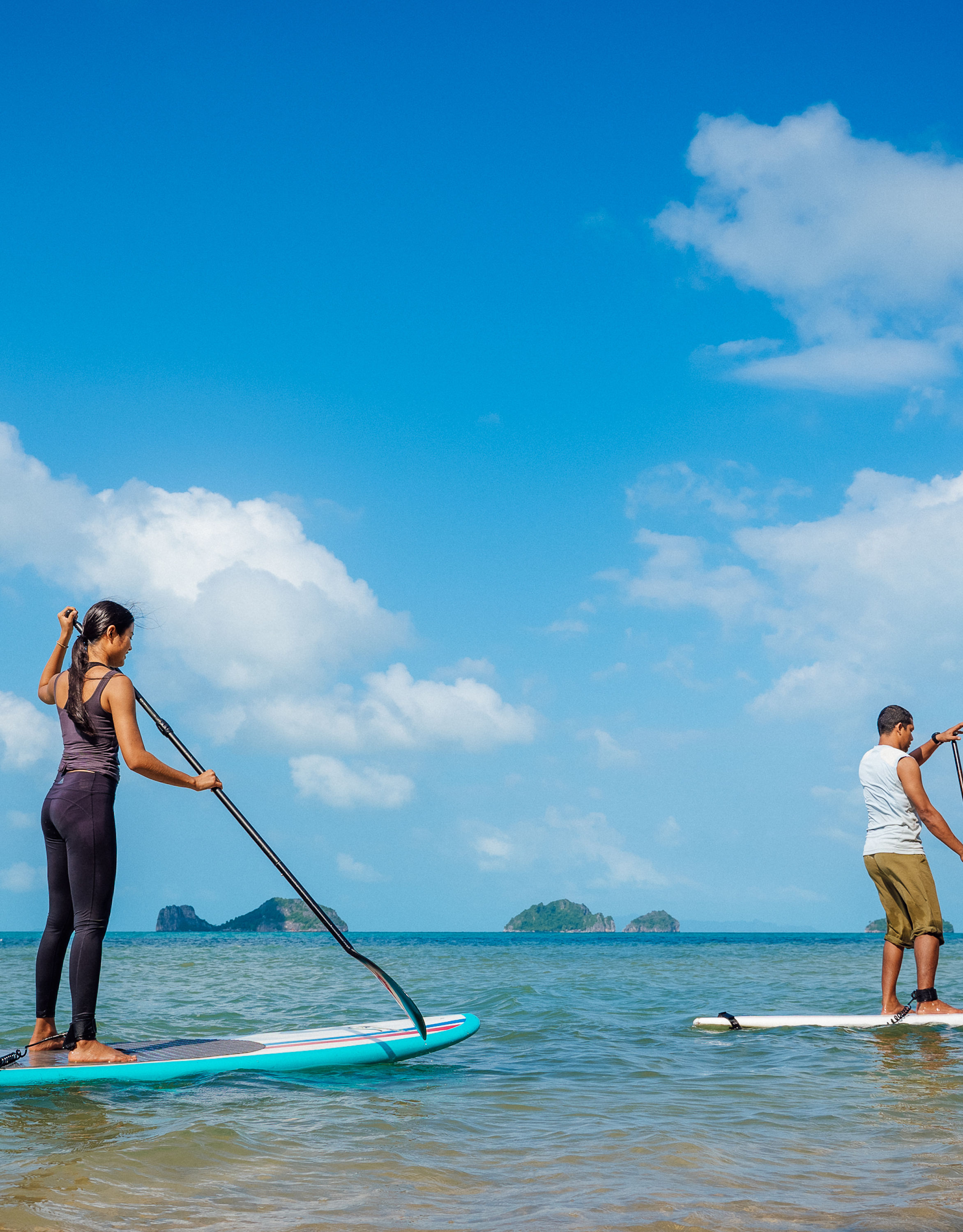 Man and Woman on a Surfboard on the Water