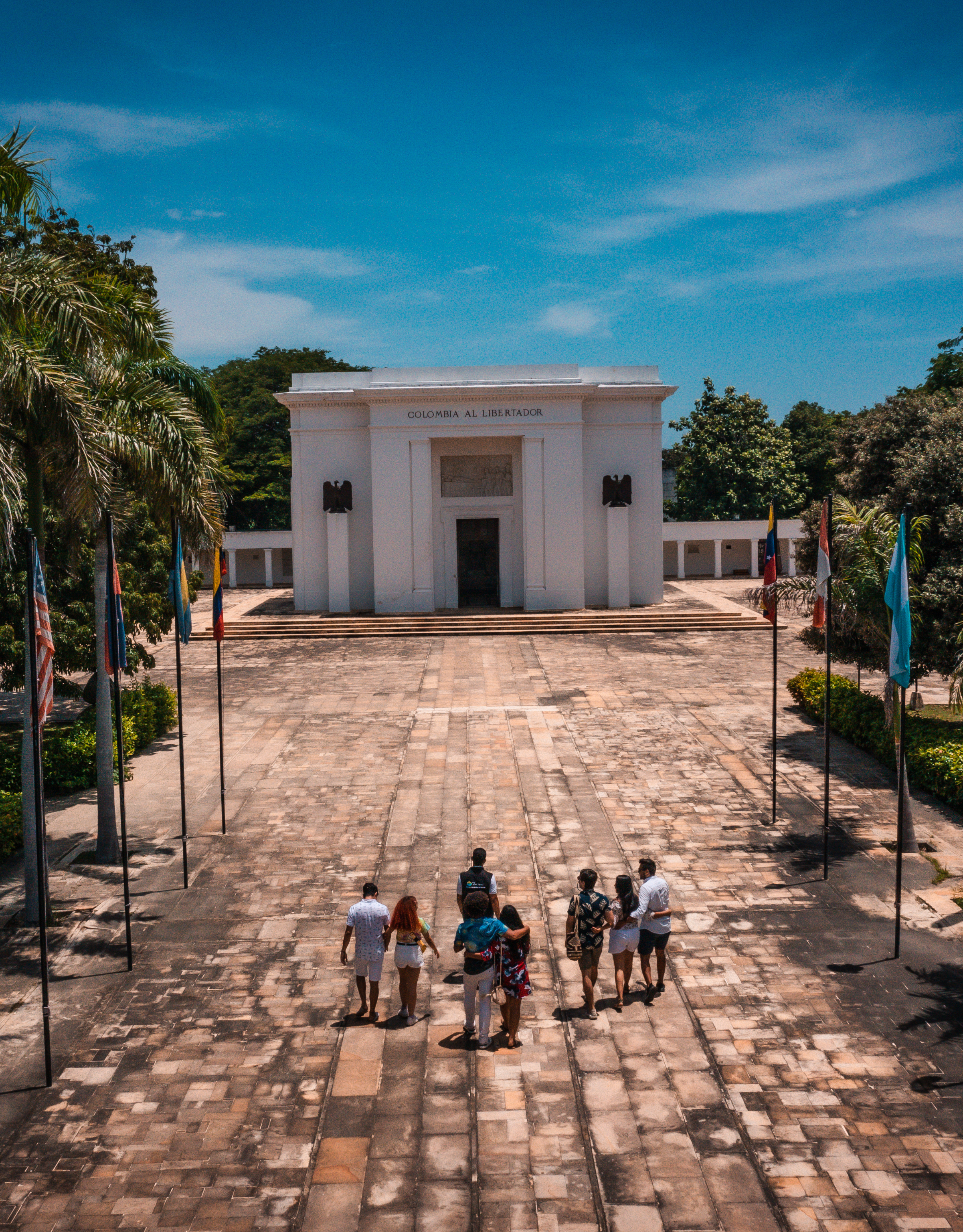 People walking up to historical building