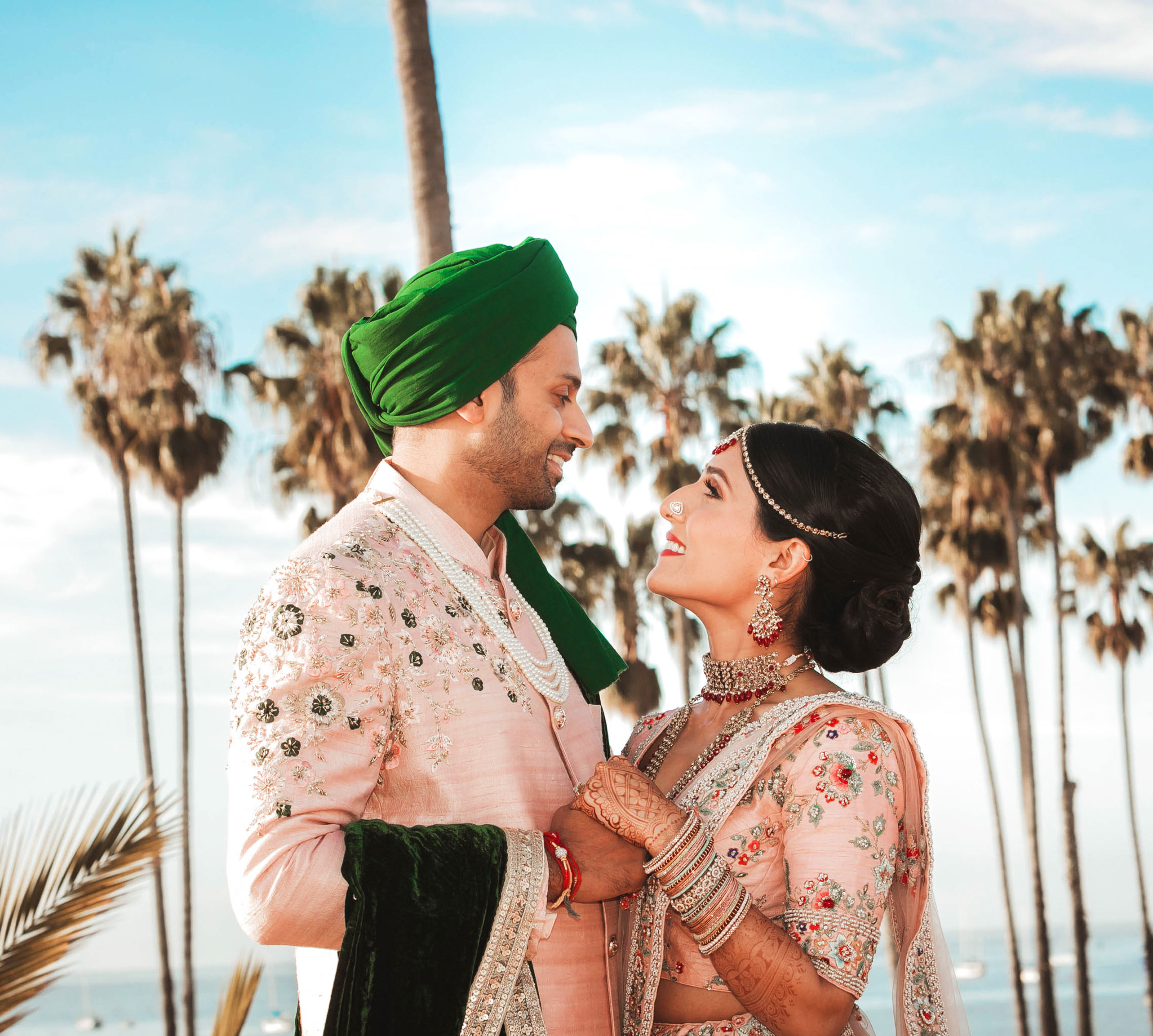 Couple with trees and water in background