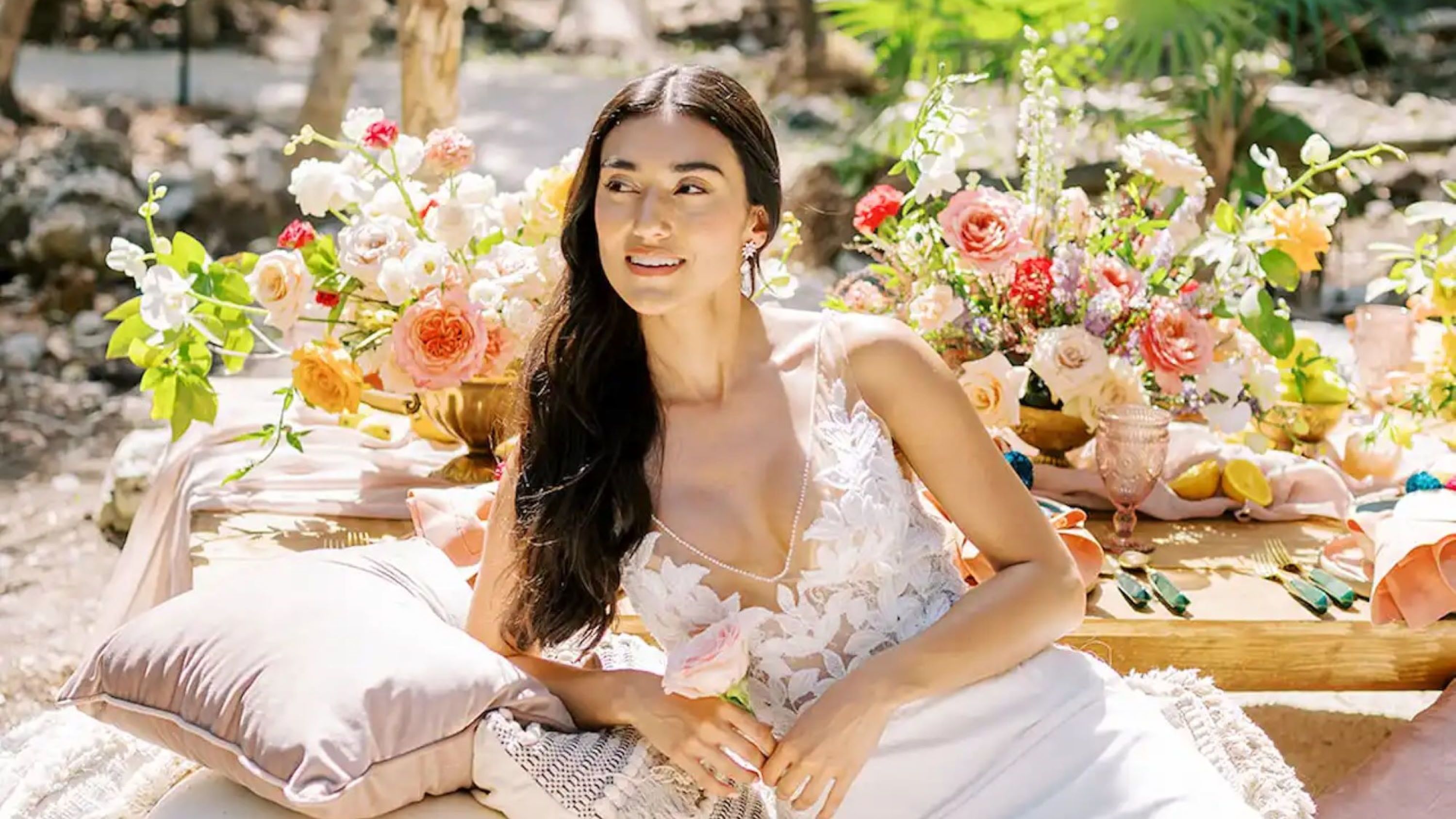 Bride lying on cushion outdoors