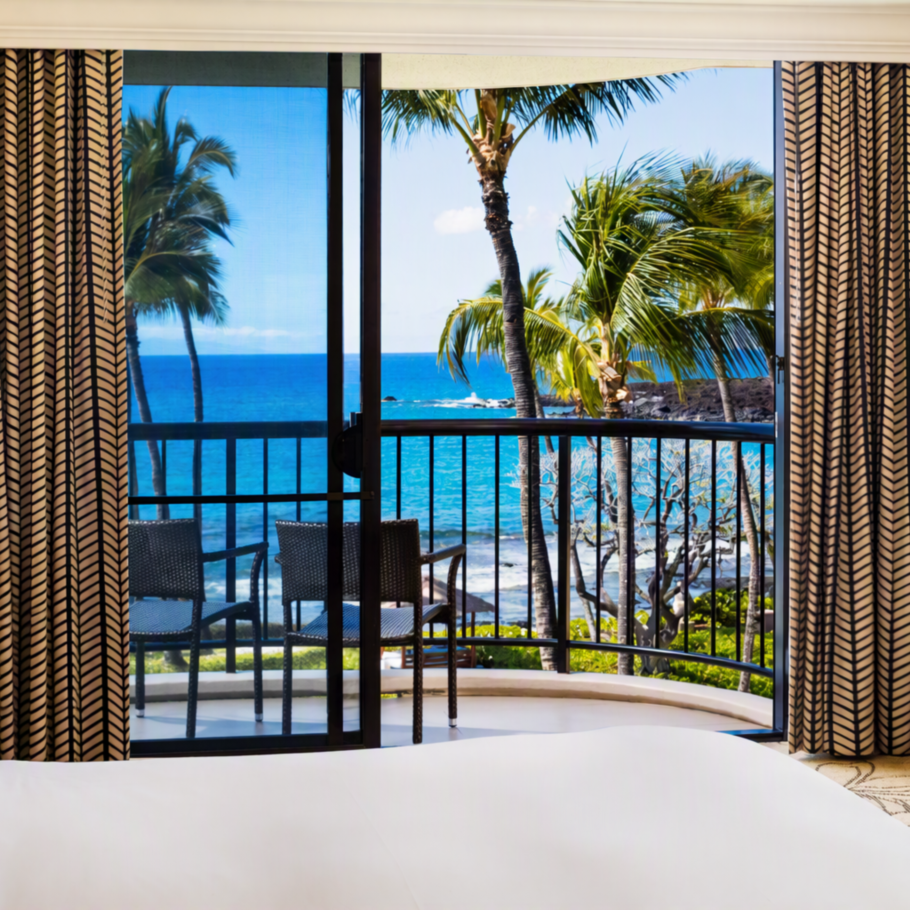 Large Bed in a Guest Room with Ocean View from Balcony