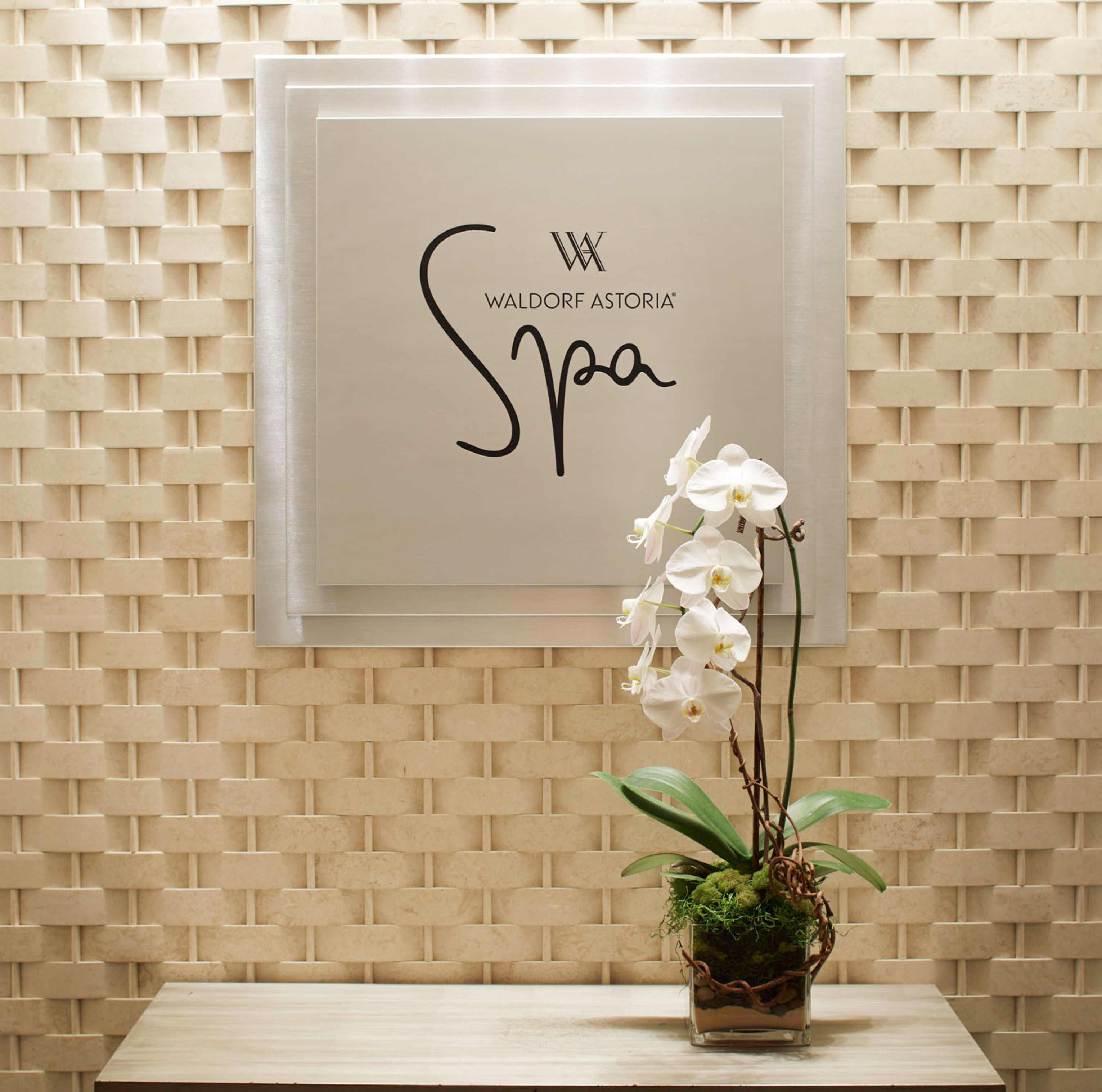 spa entrance sign, white orchid flowers in a pot