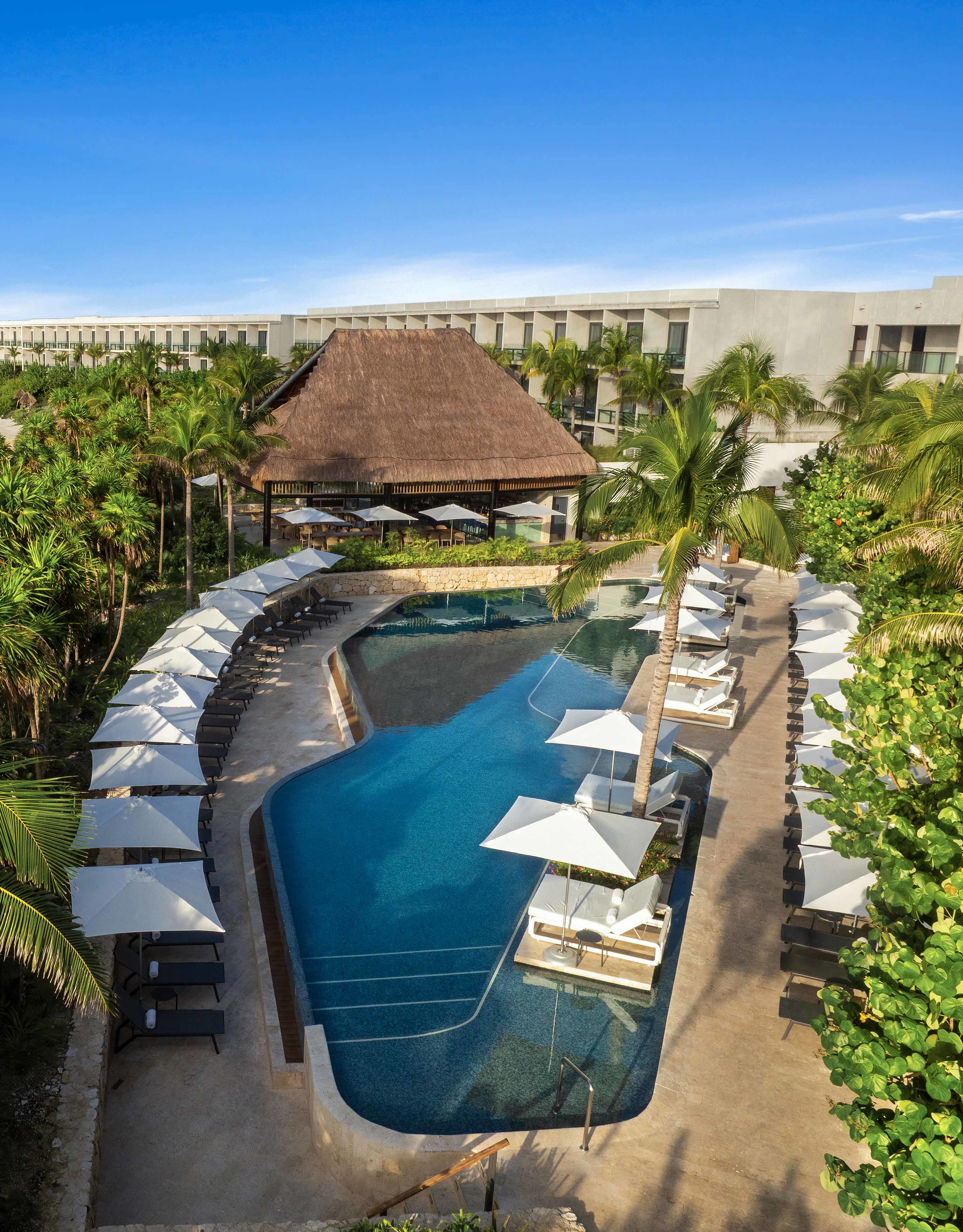 Vue aérienne de l'extérieur de l'hôtel, piscines extérieures, hutte tiki et plage