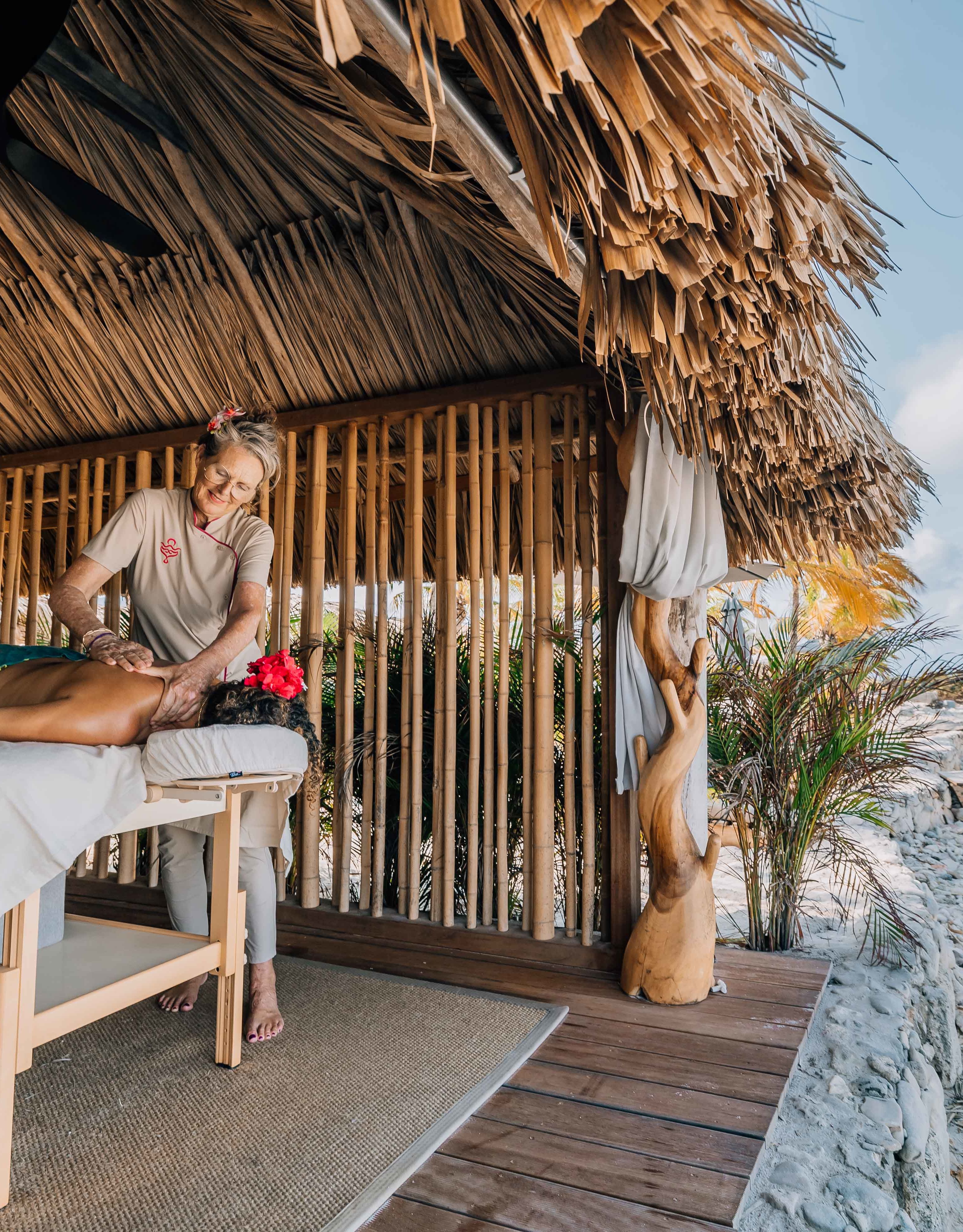 Woman receiving massage in a luxurious oceanfront cabana