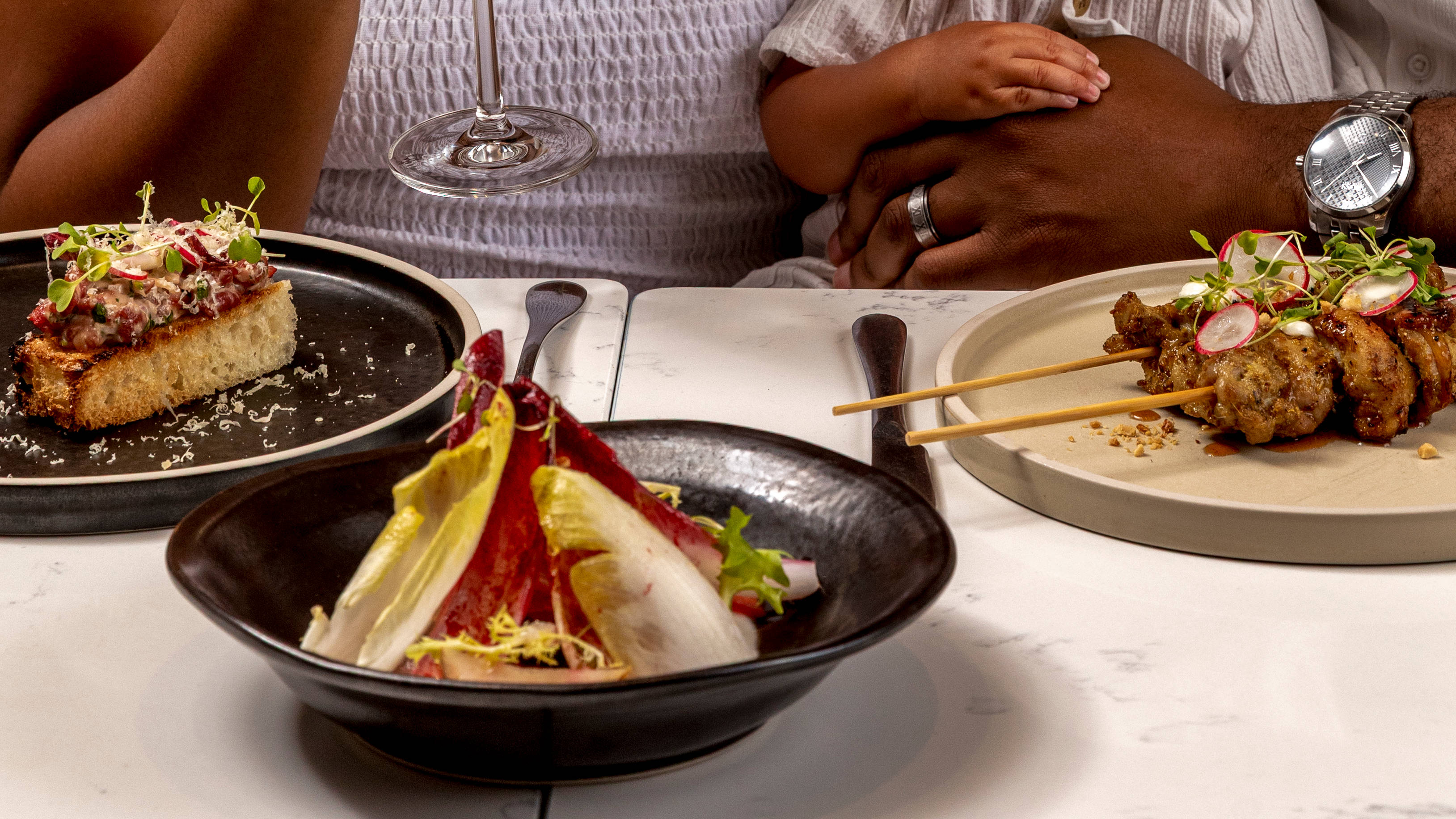 Couple with a Small Child Dining in a Restaurant