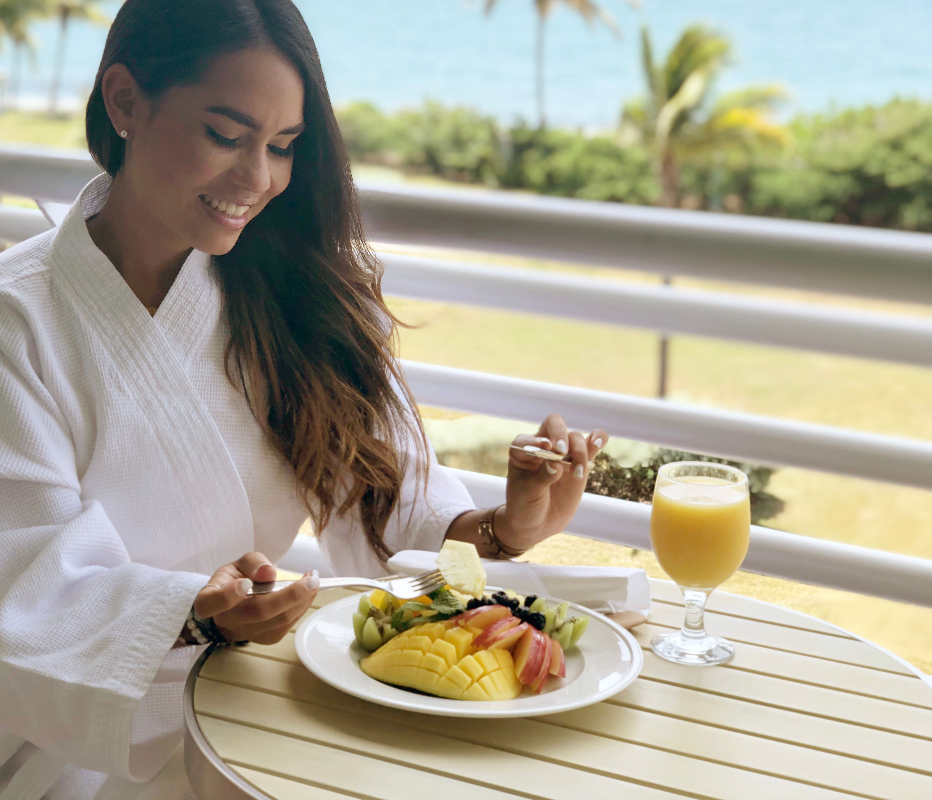 Woman enjoying breakfast on balcony