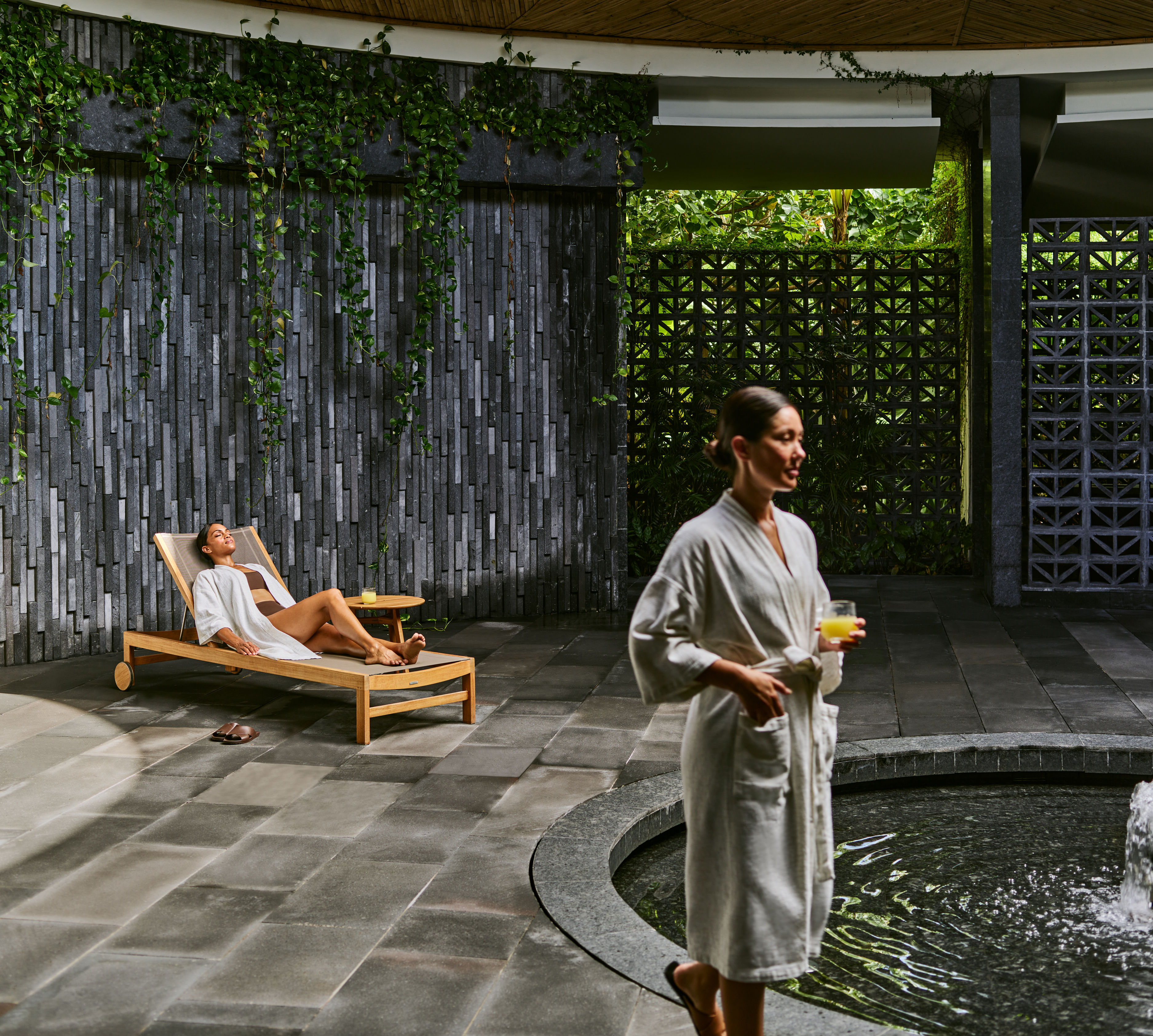 Man and woman relaxing by water feature
