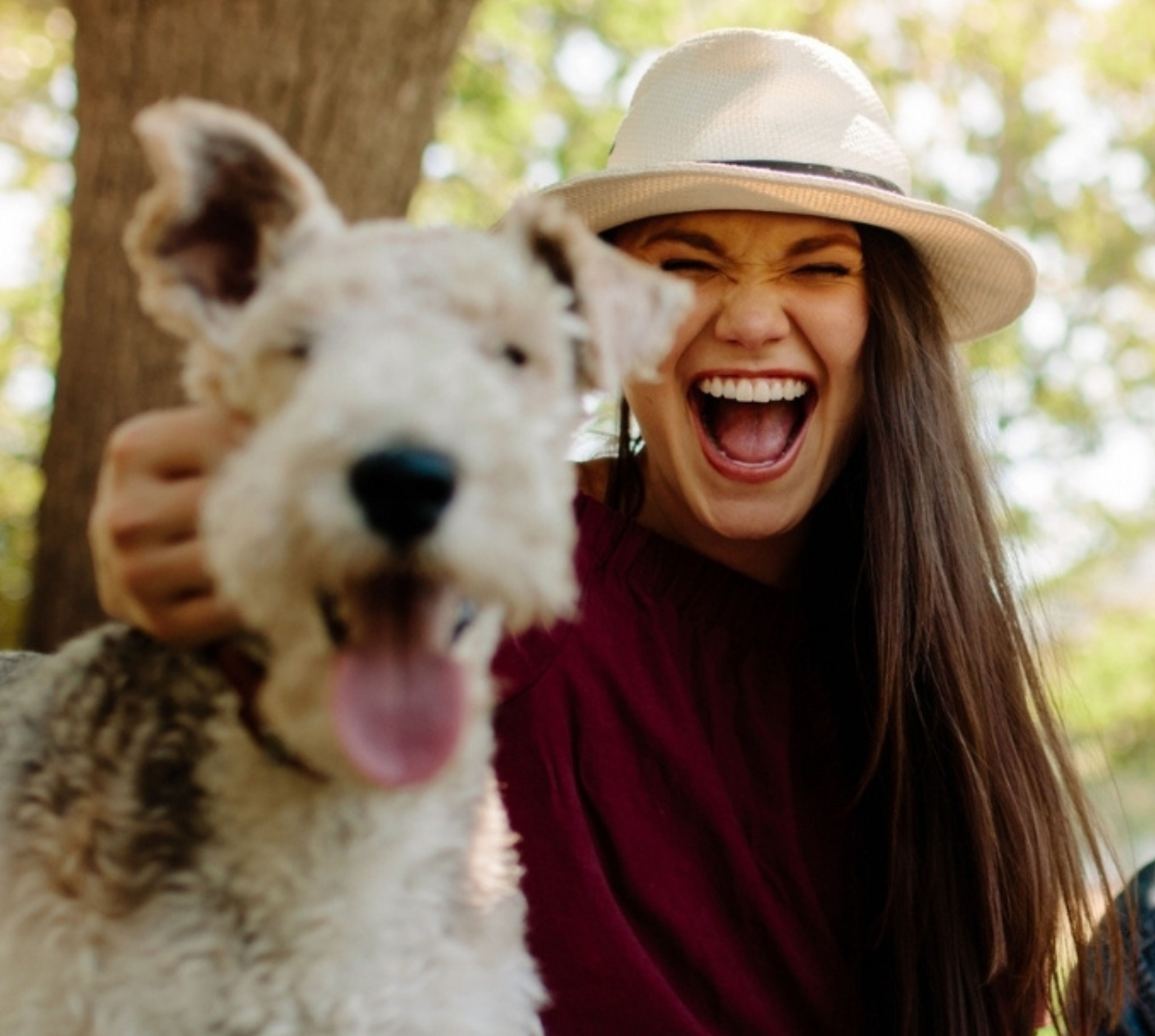 Close-up of a young couple playing with their dog