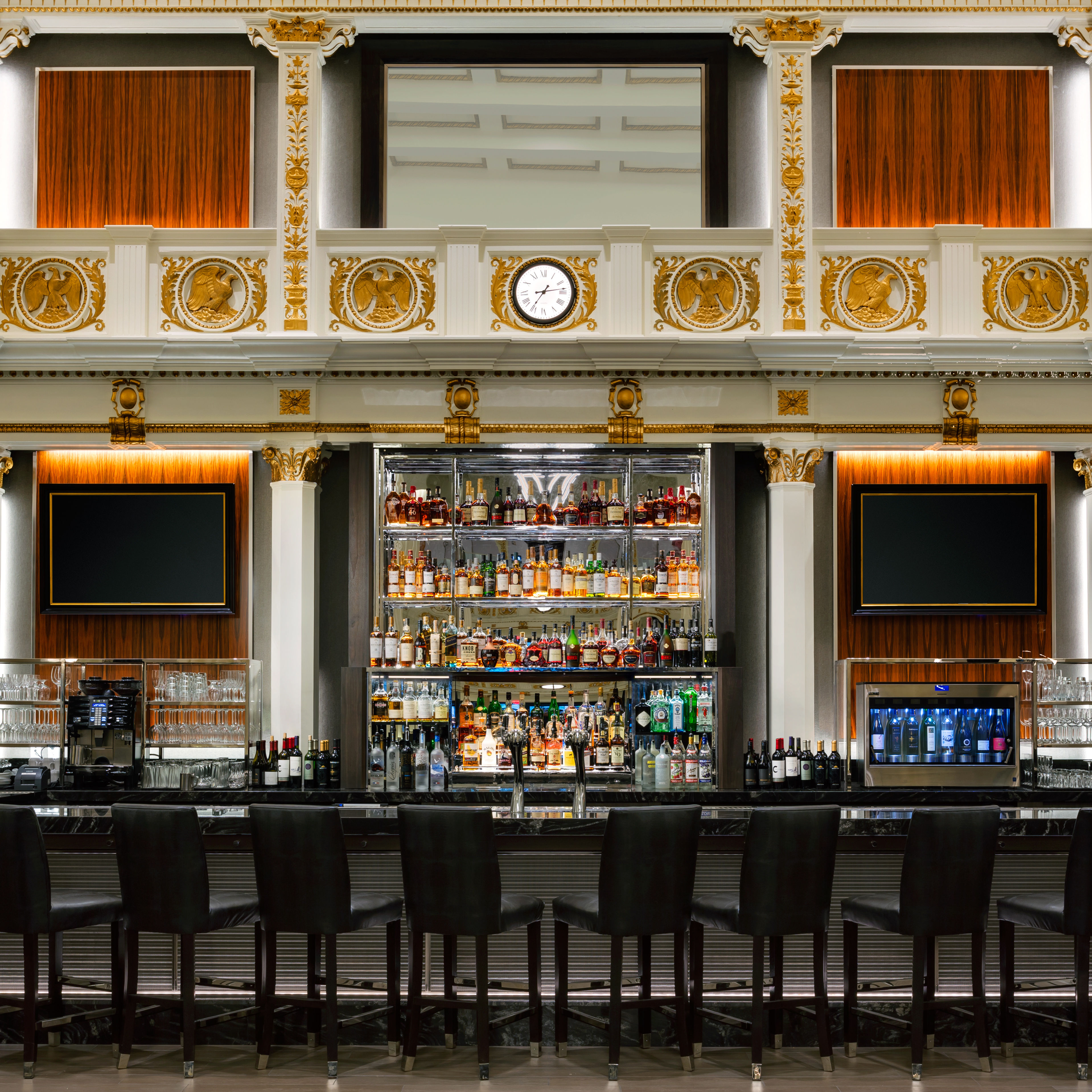 Bar area with stools and TVs