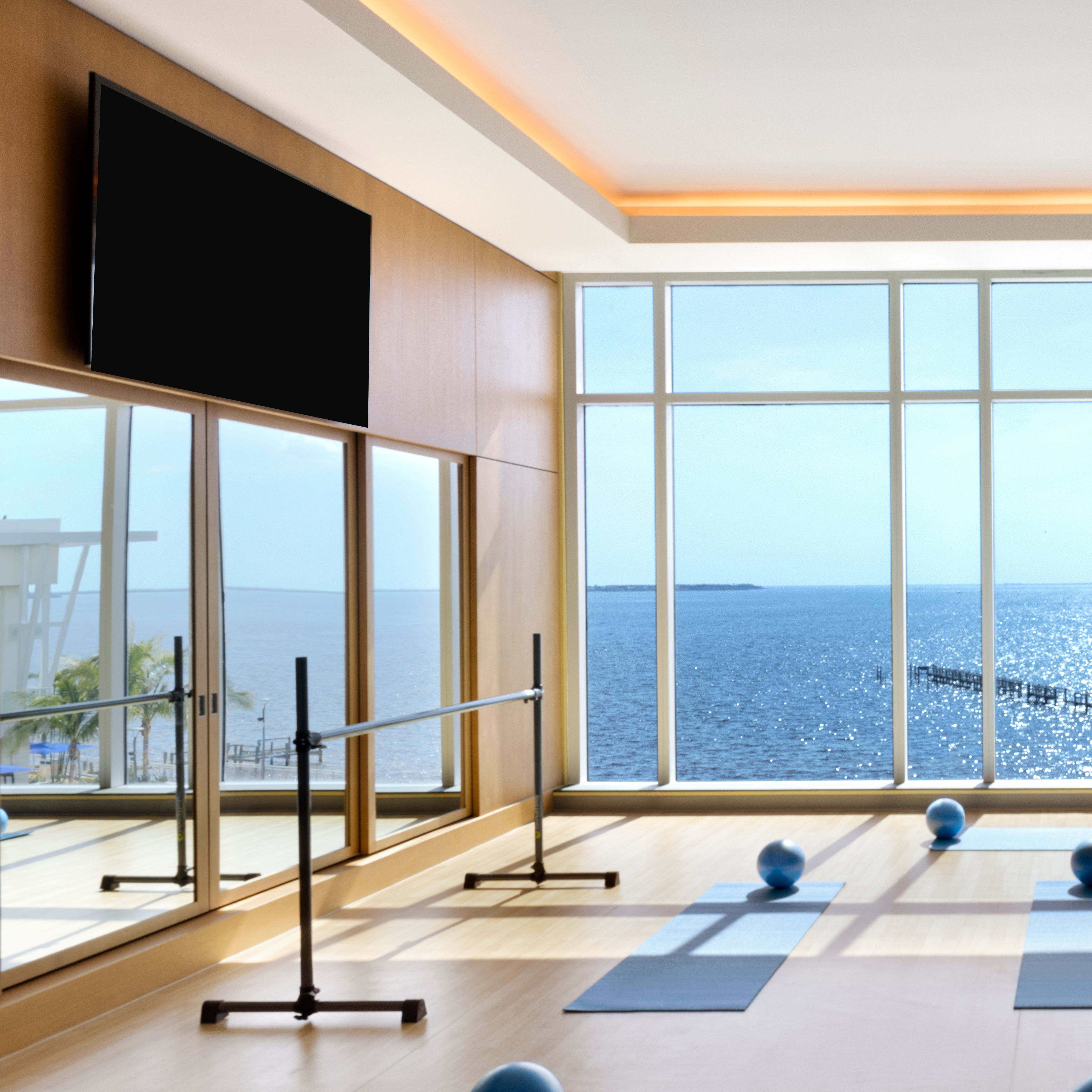 Fitness Center with TV, Exercise Balls on Mats and Large Windows with Water View