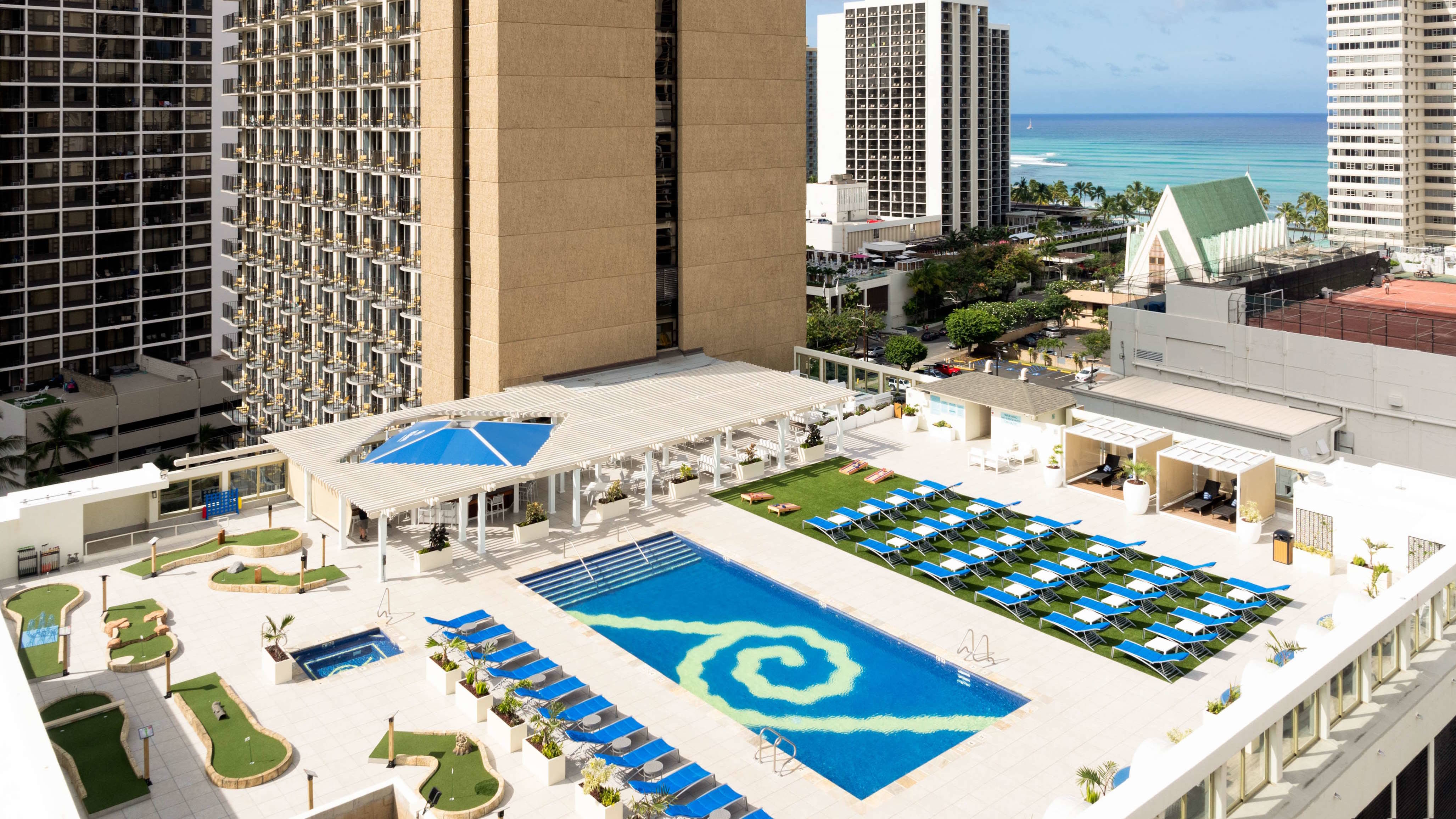 arial view of the outdoor pool, pool bar, lounge chairs, mini golf course