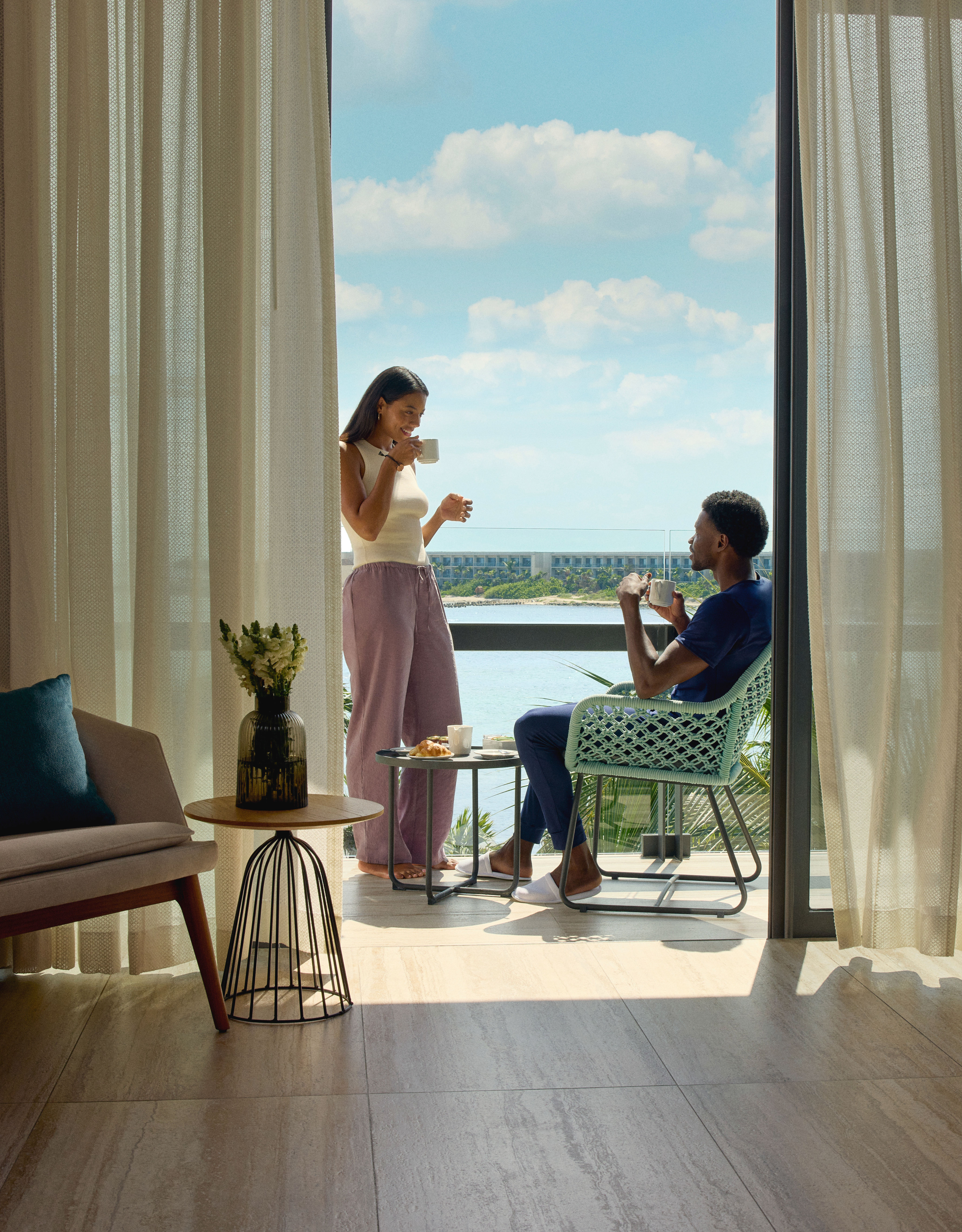 Man and woman enjoying breakfast on the terrace of their suite
