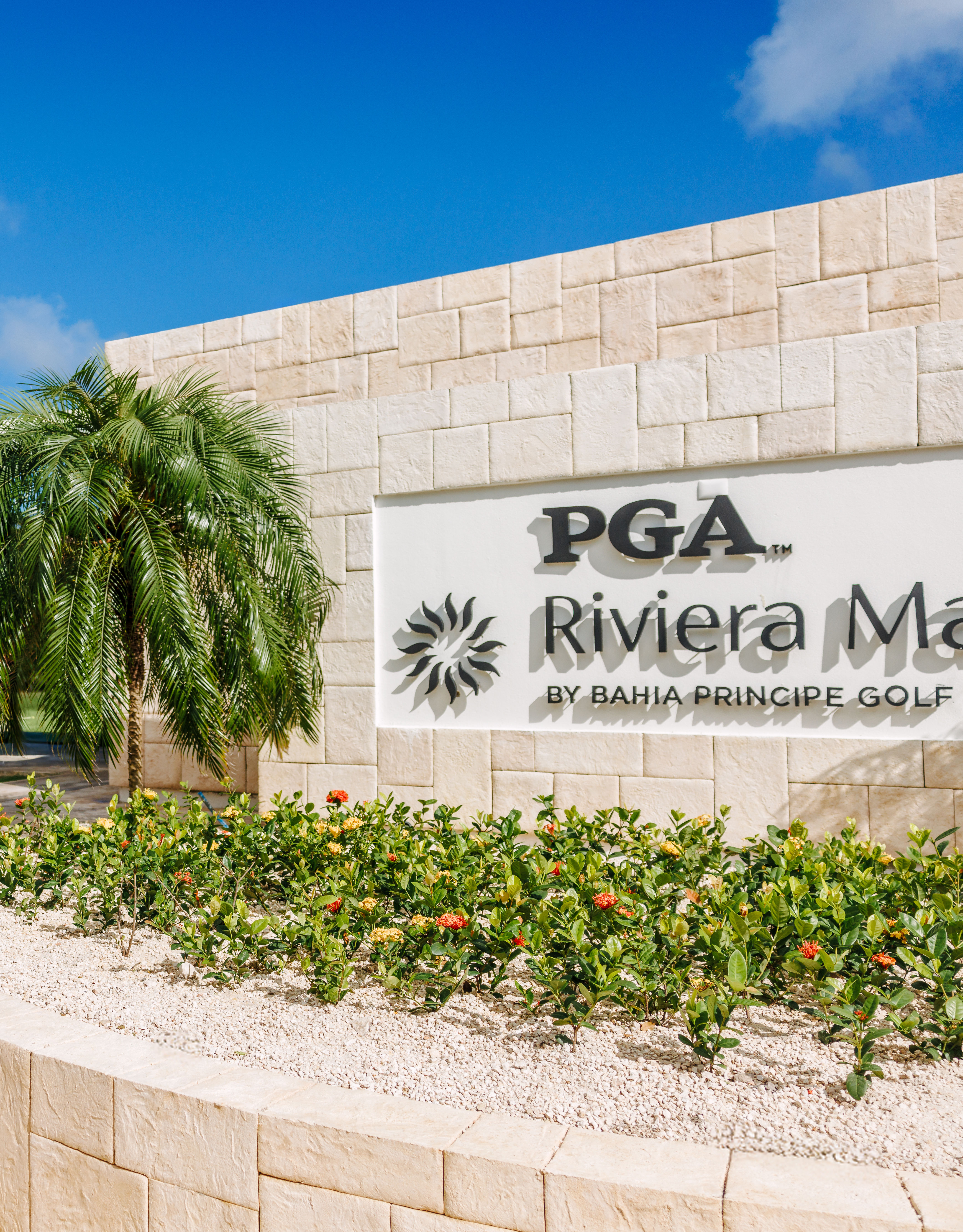 Two Women Walking at the Entrance of PGA Riviera Maya by Bahia Principe Golf