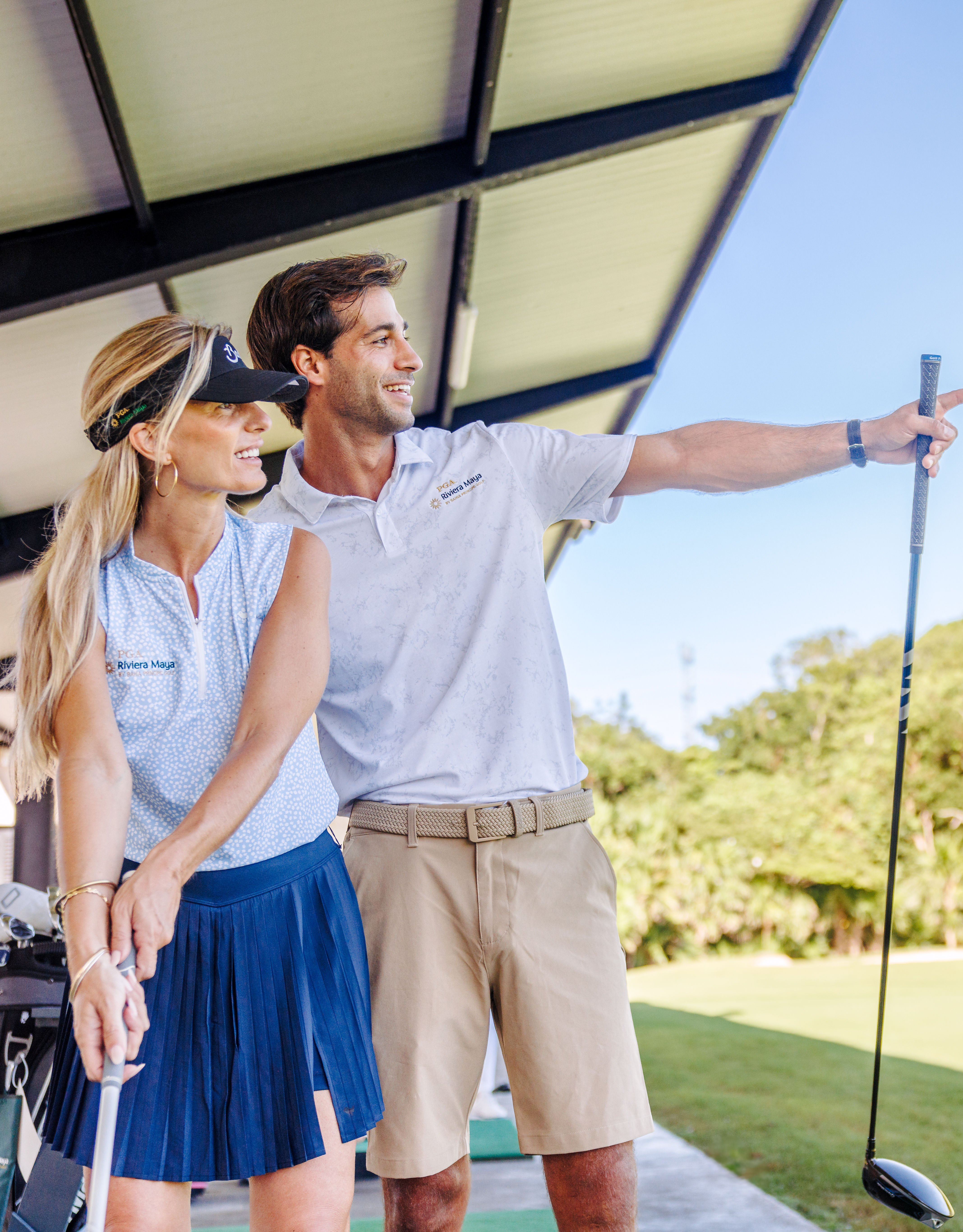 couple playing on driving range