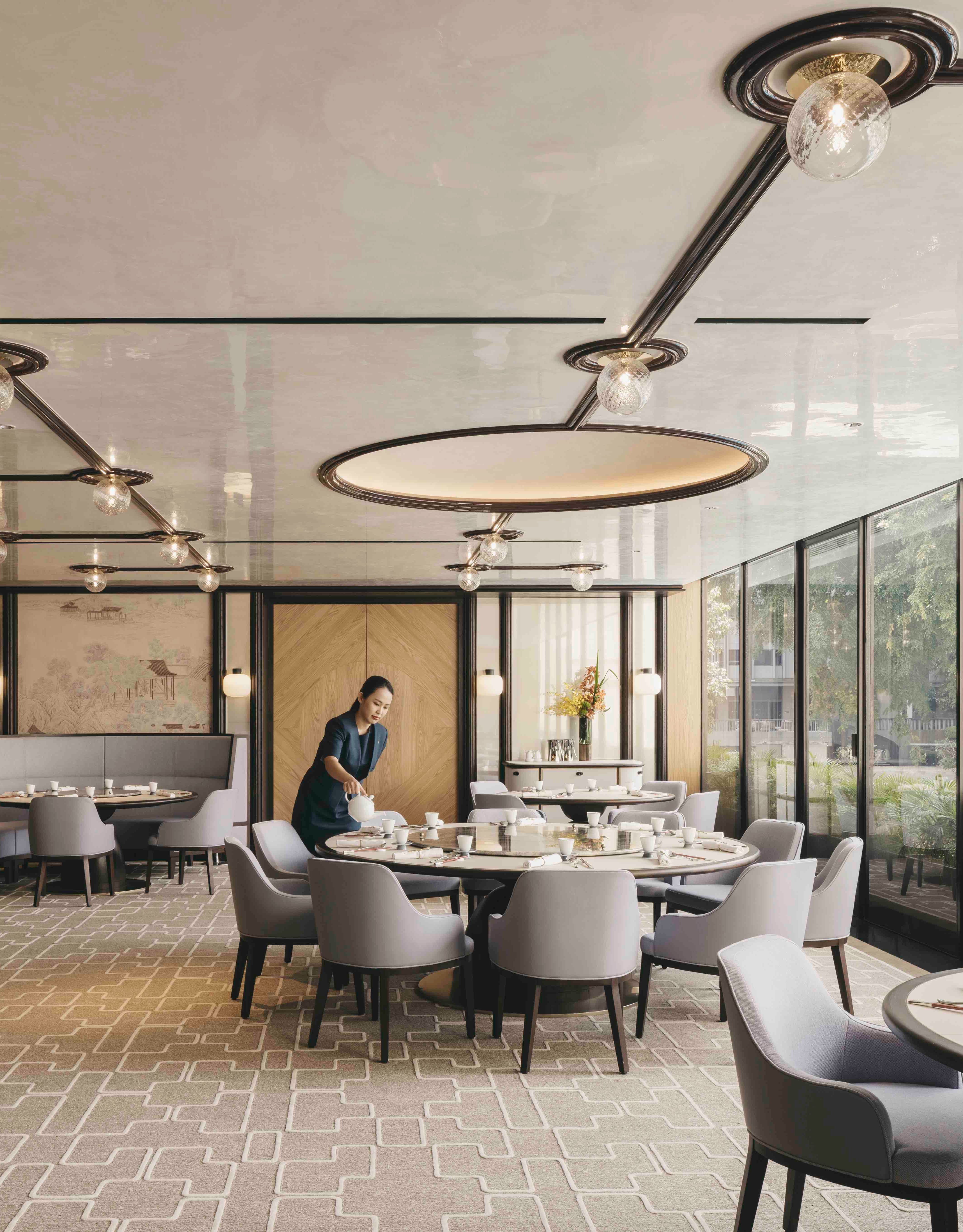 Summer Palace establishment with staff member and multiple round tables and chairs