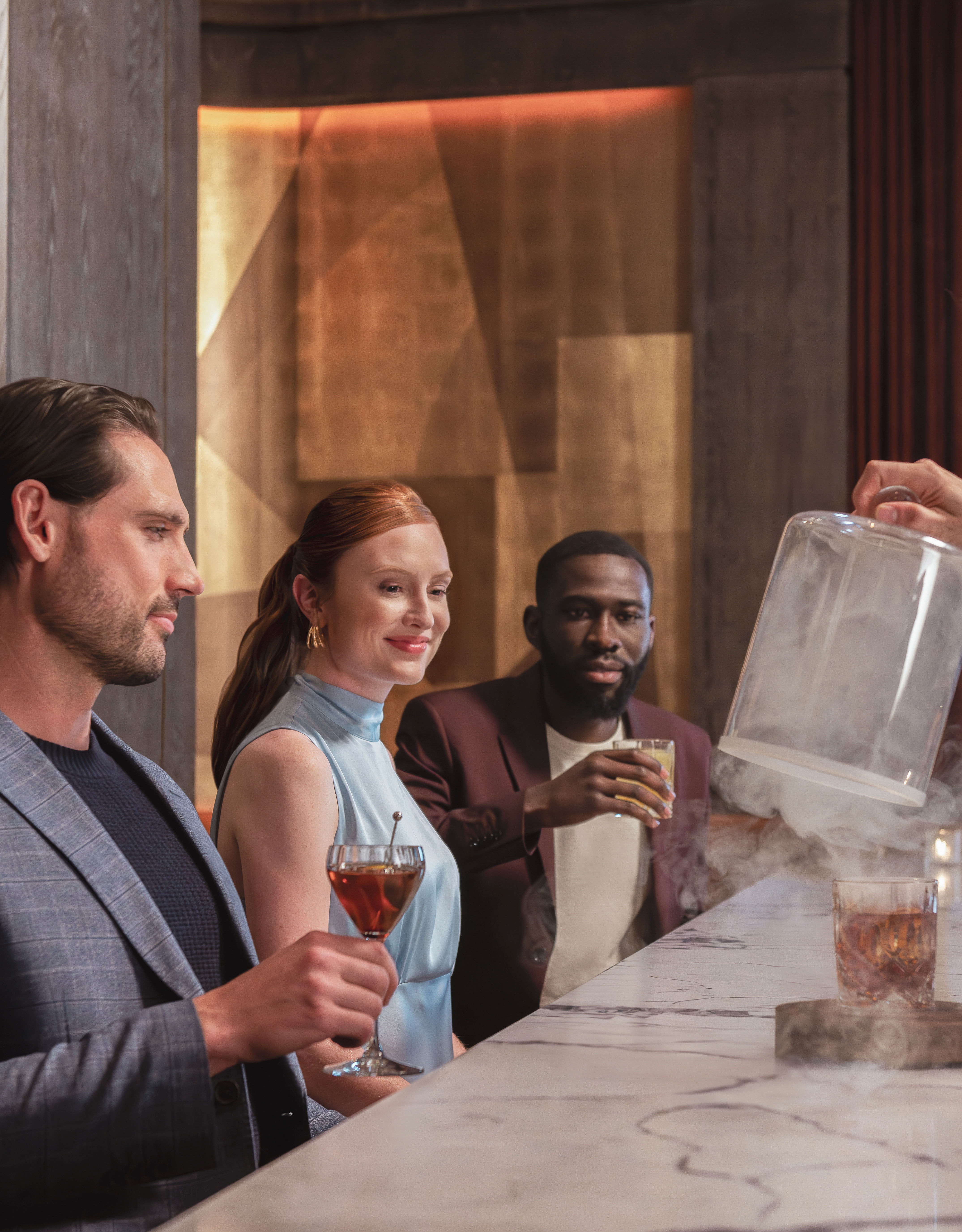 Group of people sitting at bar area with drinks