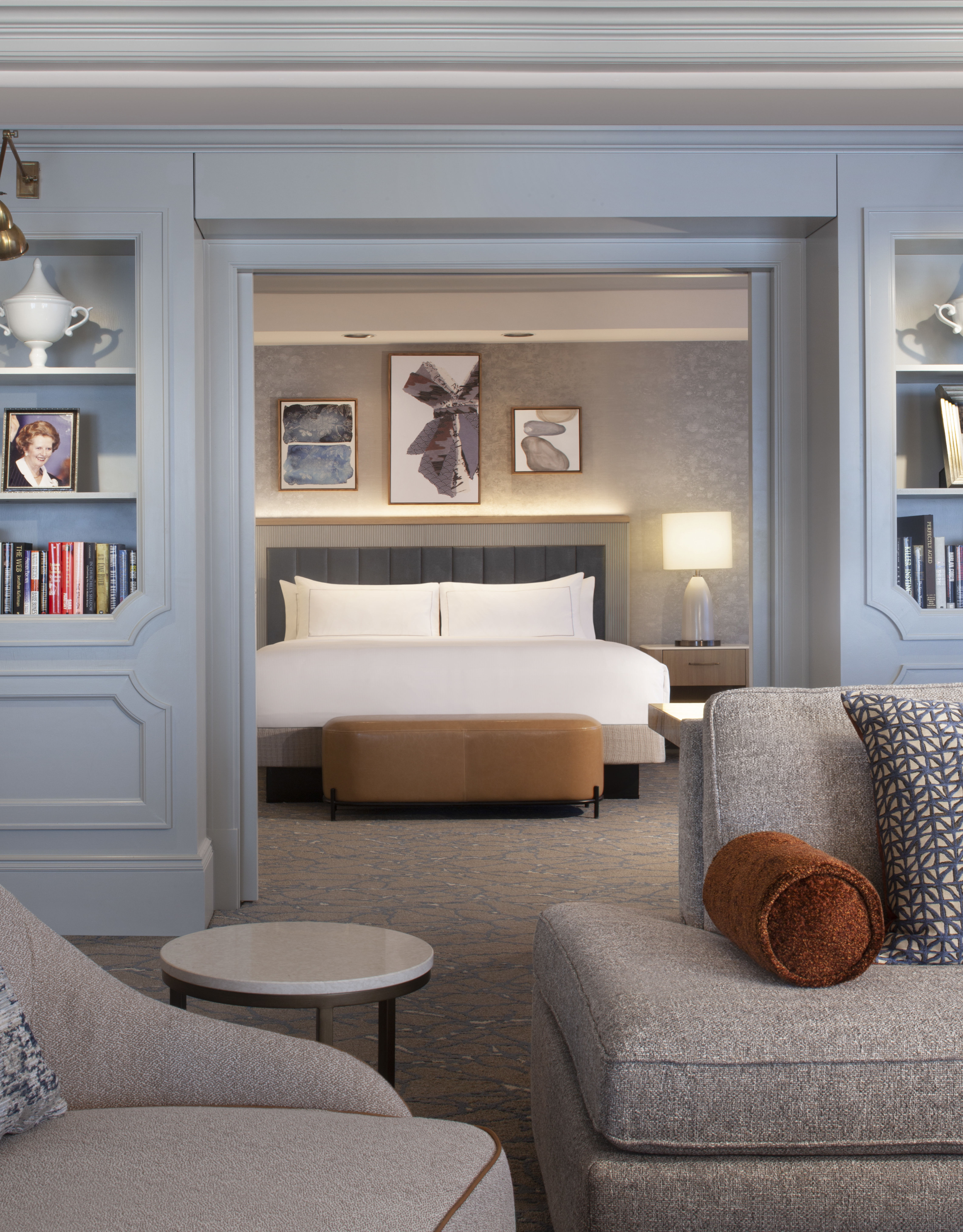 Guestroom lounge area with couch and view of bedroom