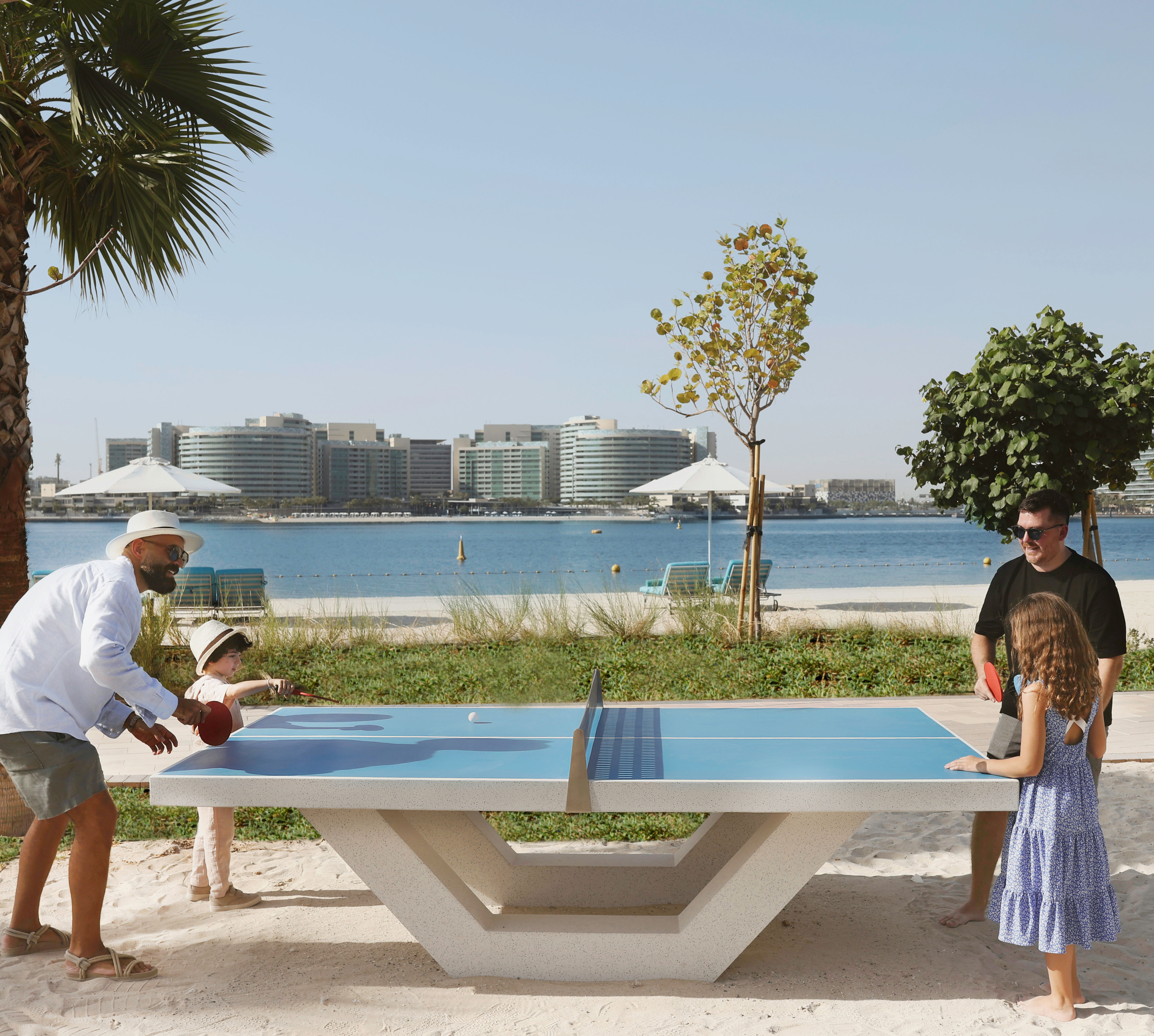 Family Playing Ping Pong at the Beach