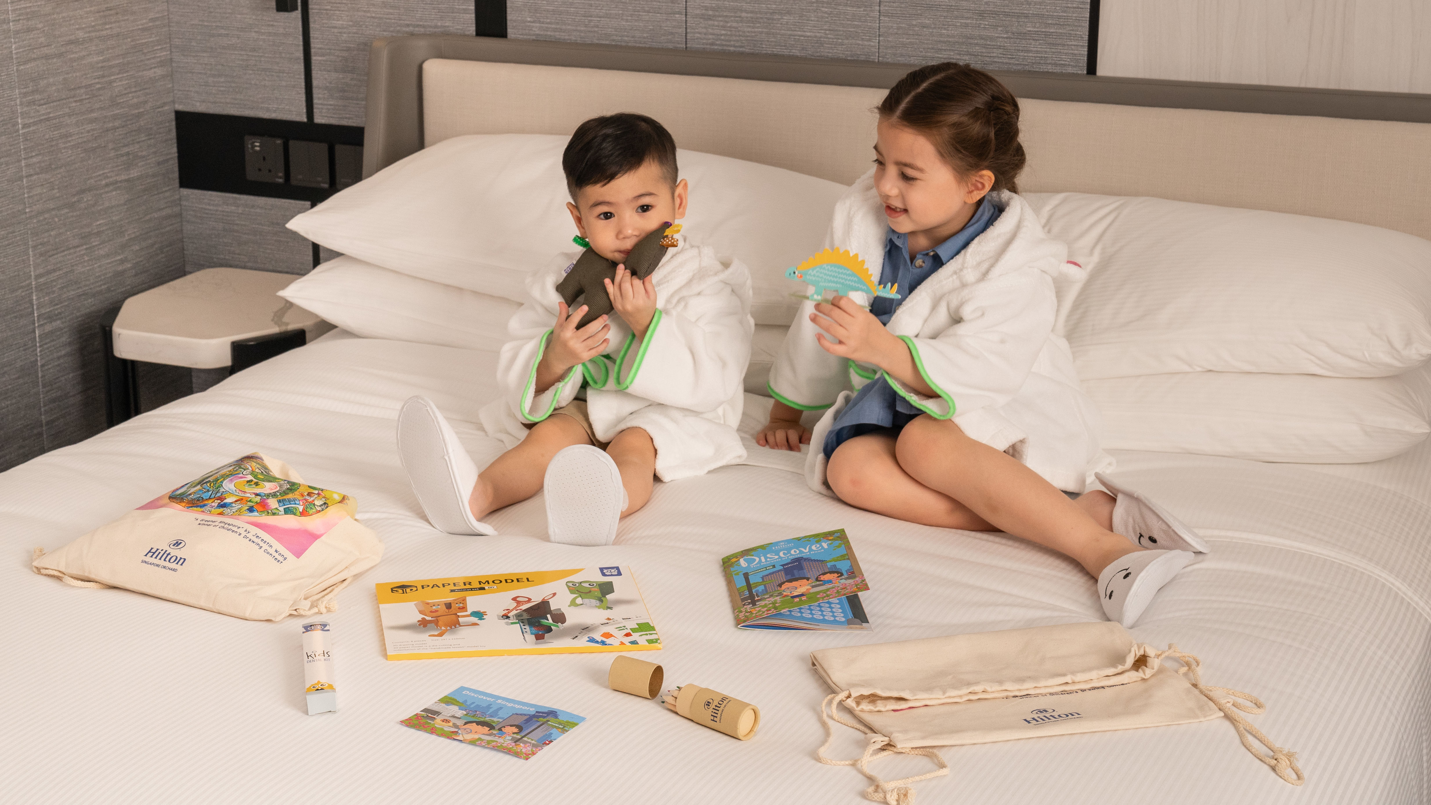 Kids on bed with toys