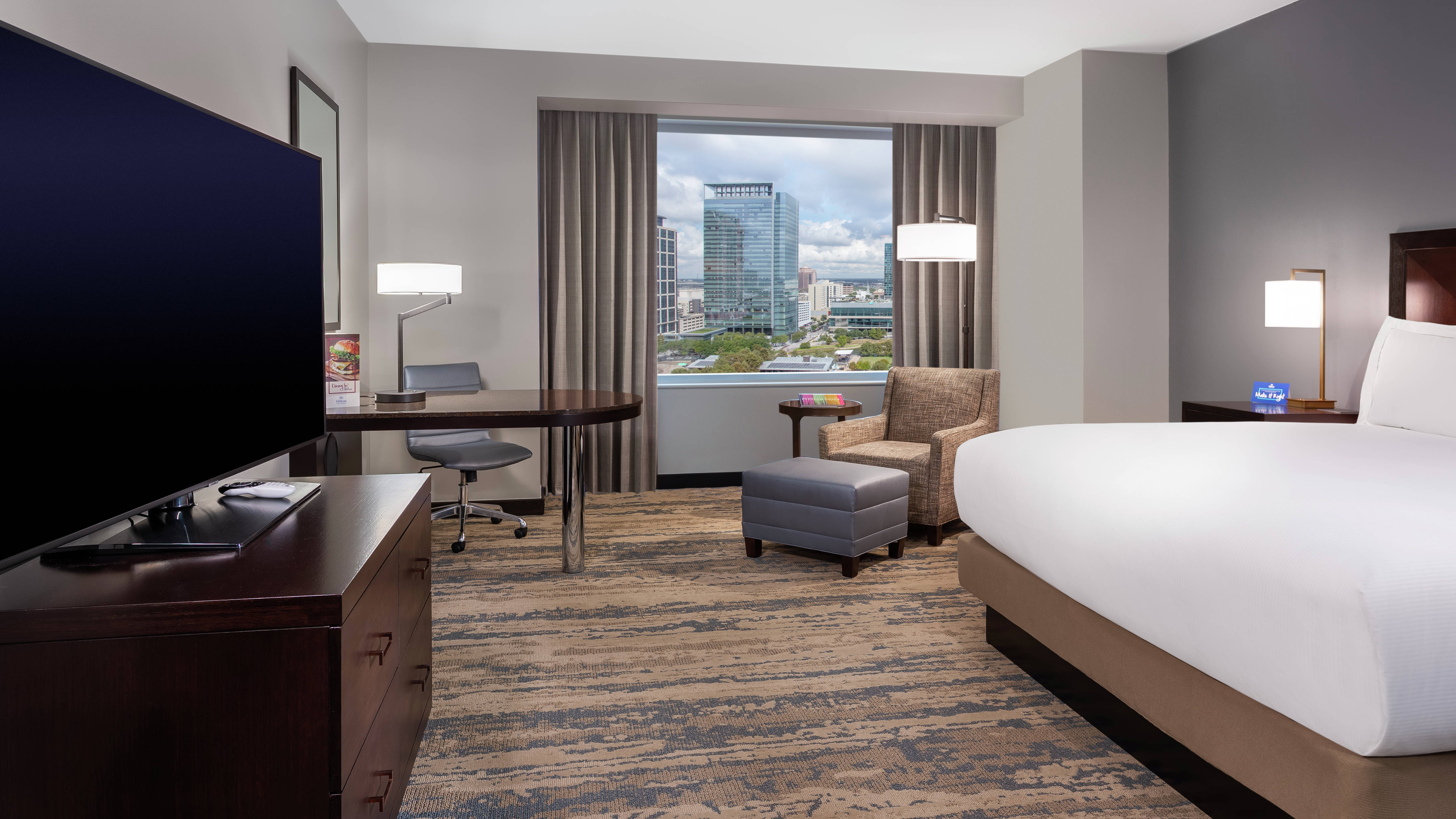 Guest Room with a king sized bed HDTV and desk