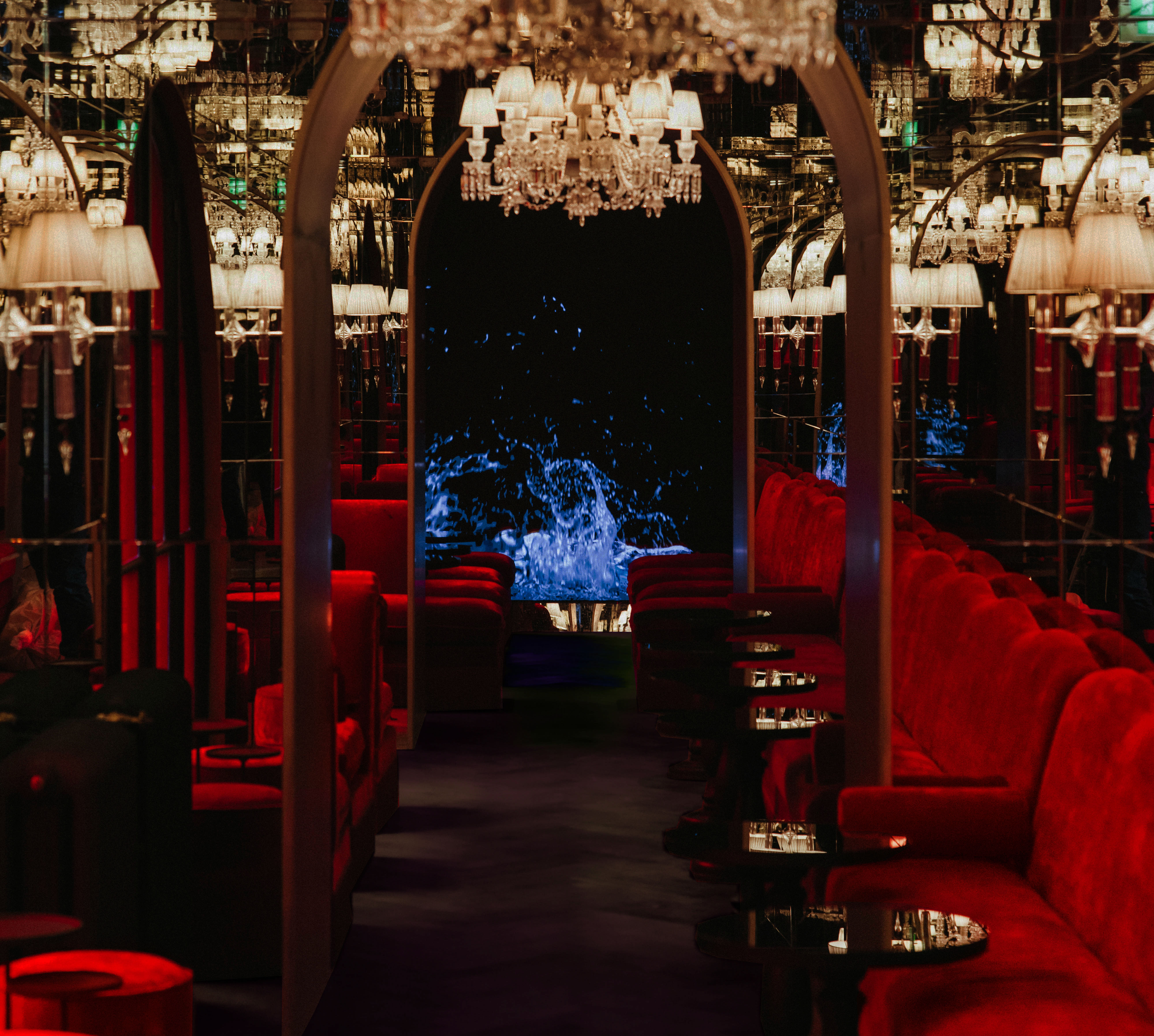 Bar avec tables rondes et canapés en velours