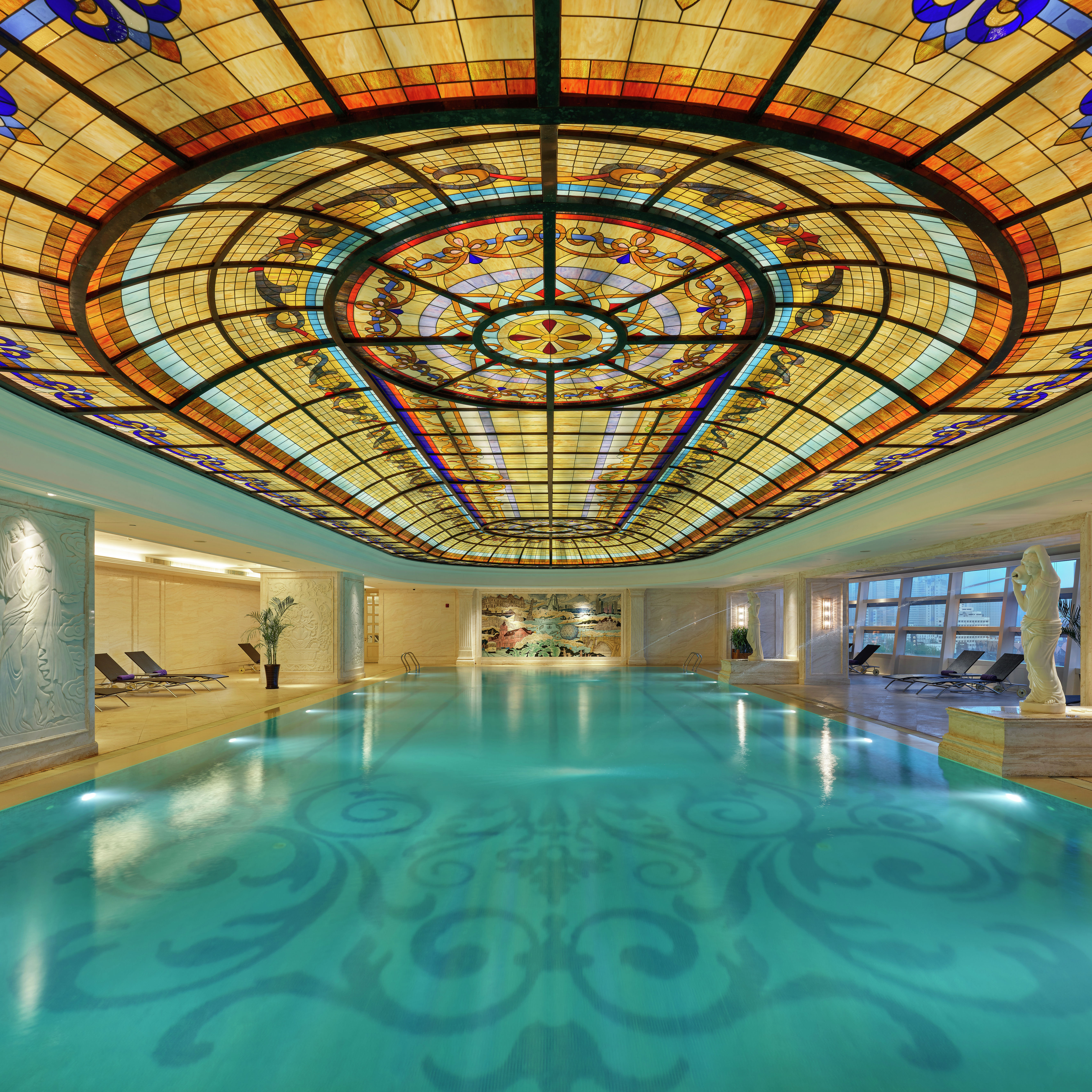 Indoor pool with ornate ceiling