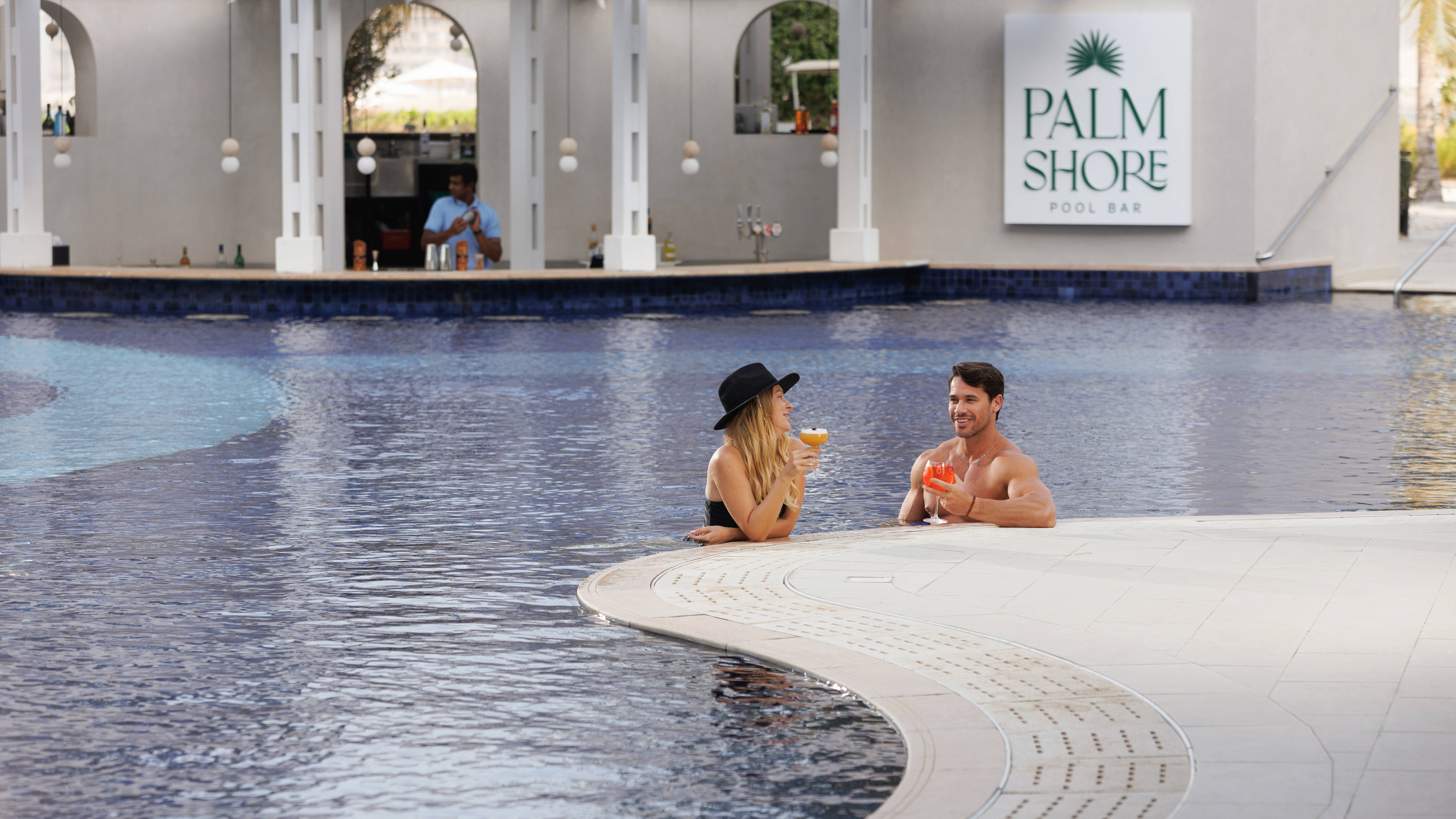 Couple Having Drinks at the Pool Bar
