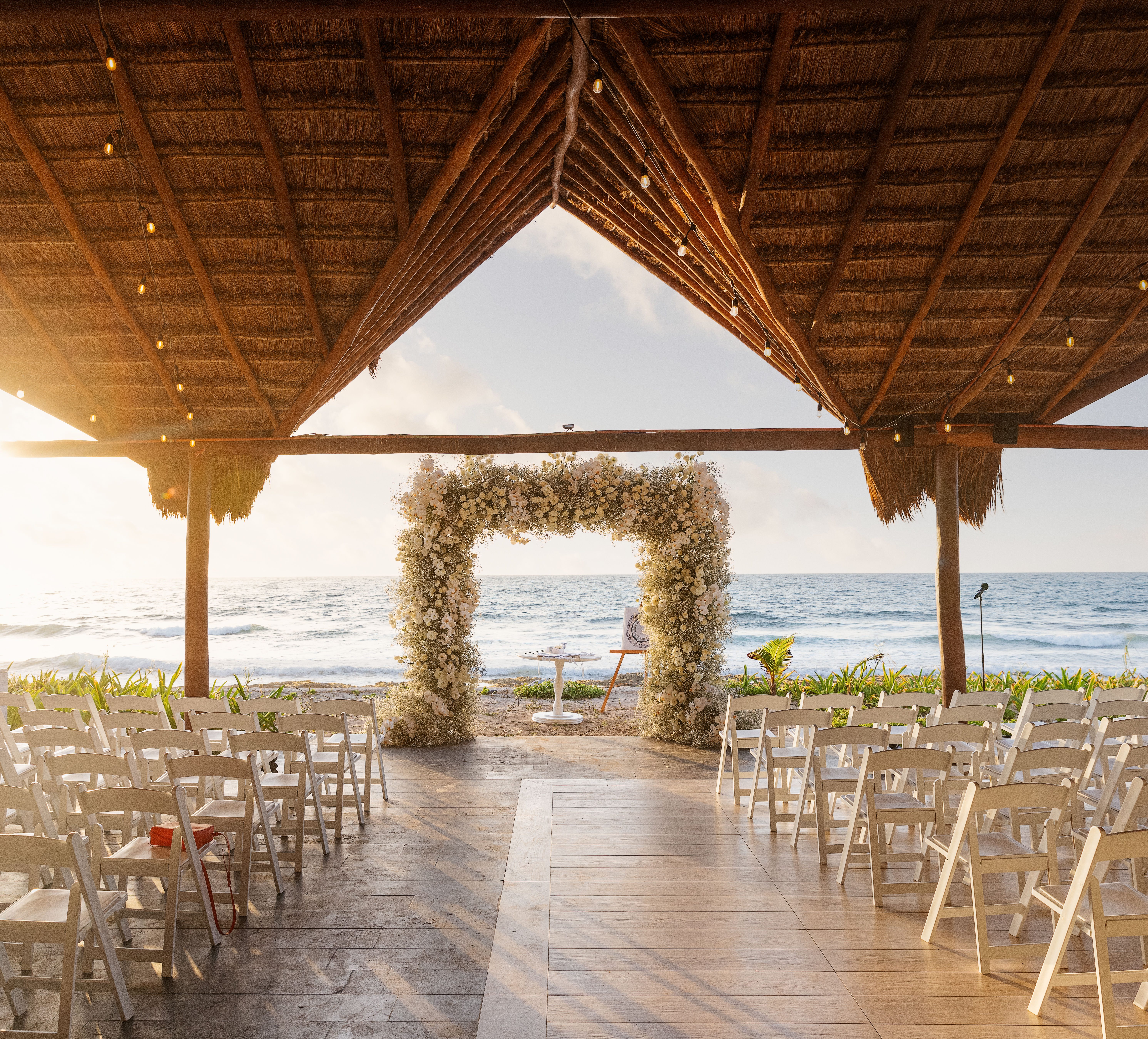 Wedding venue set up with chairs for guests and arch on oceanfront