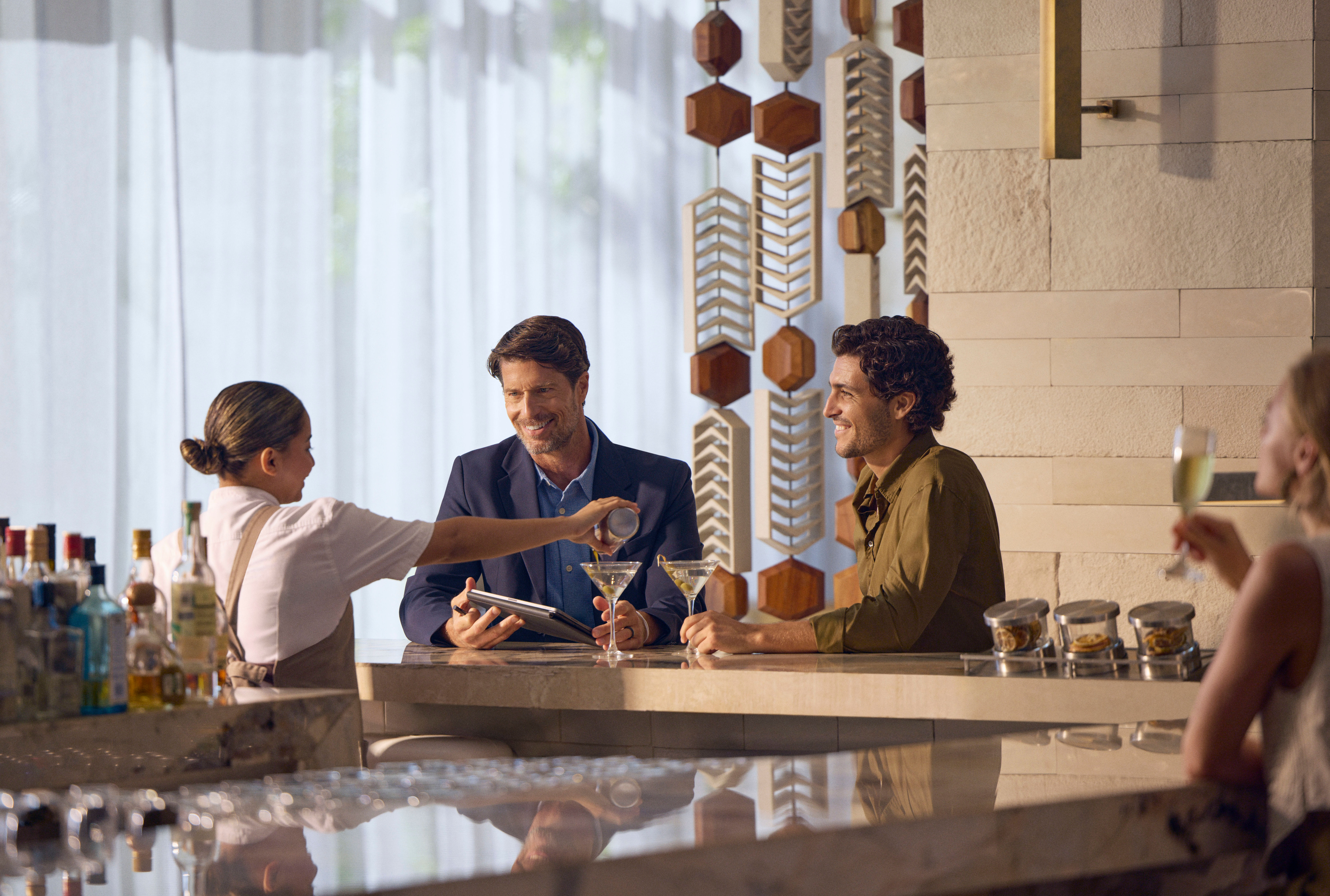 Two men ordering drinks at the hotel bar