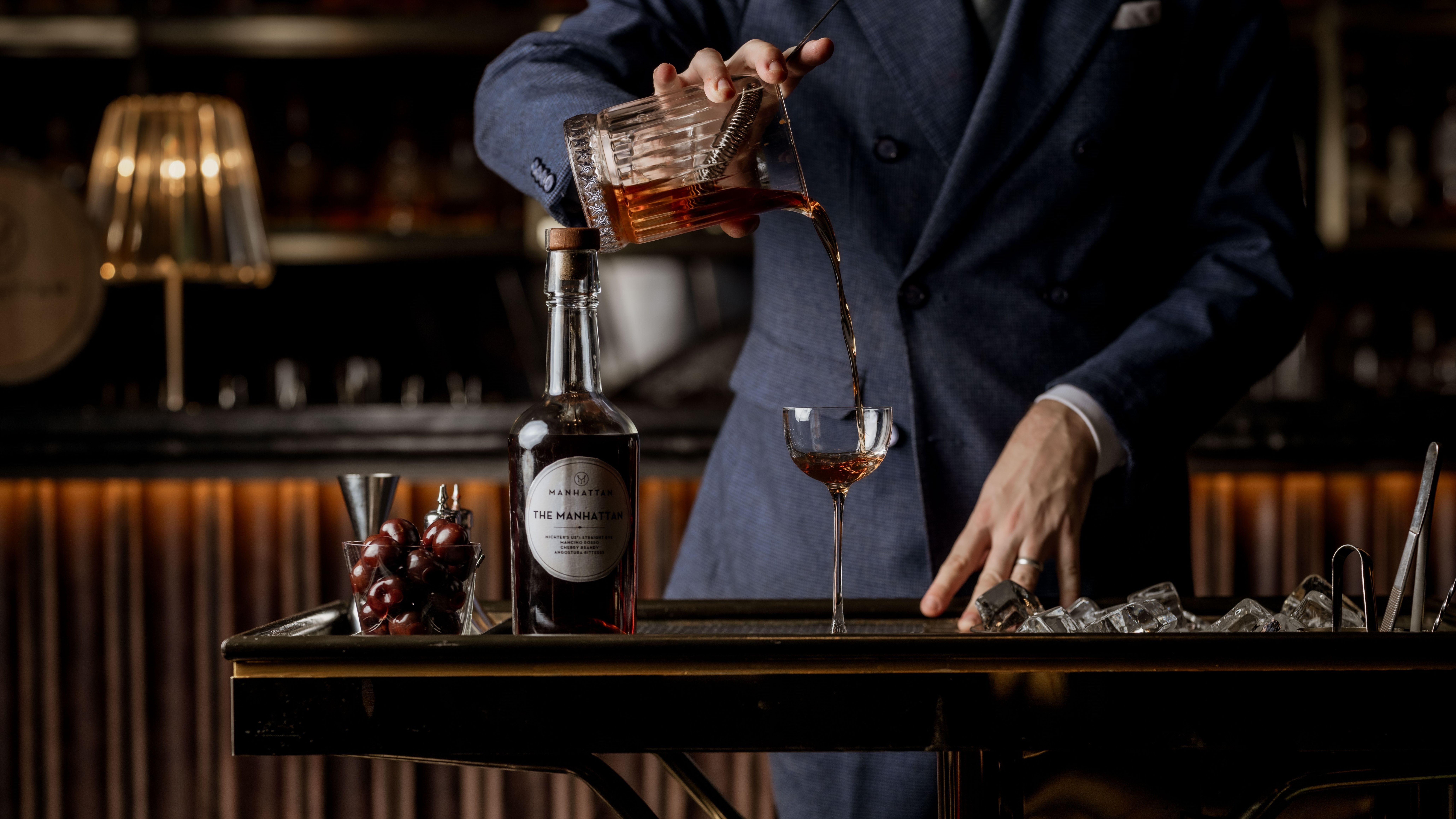 Staff member pouring liquid into a glass