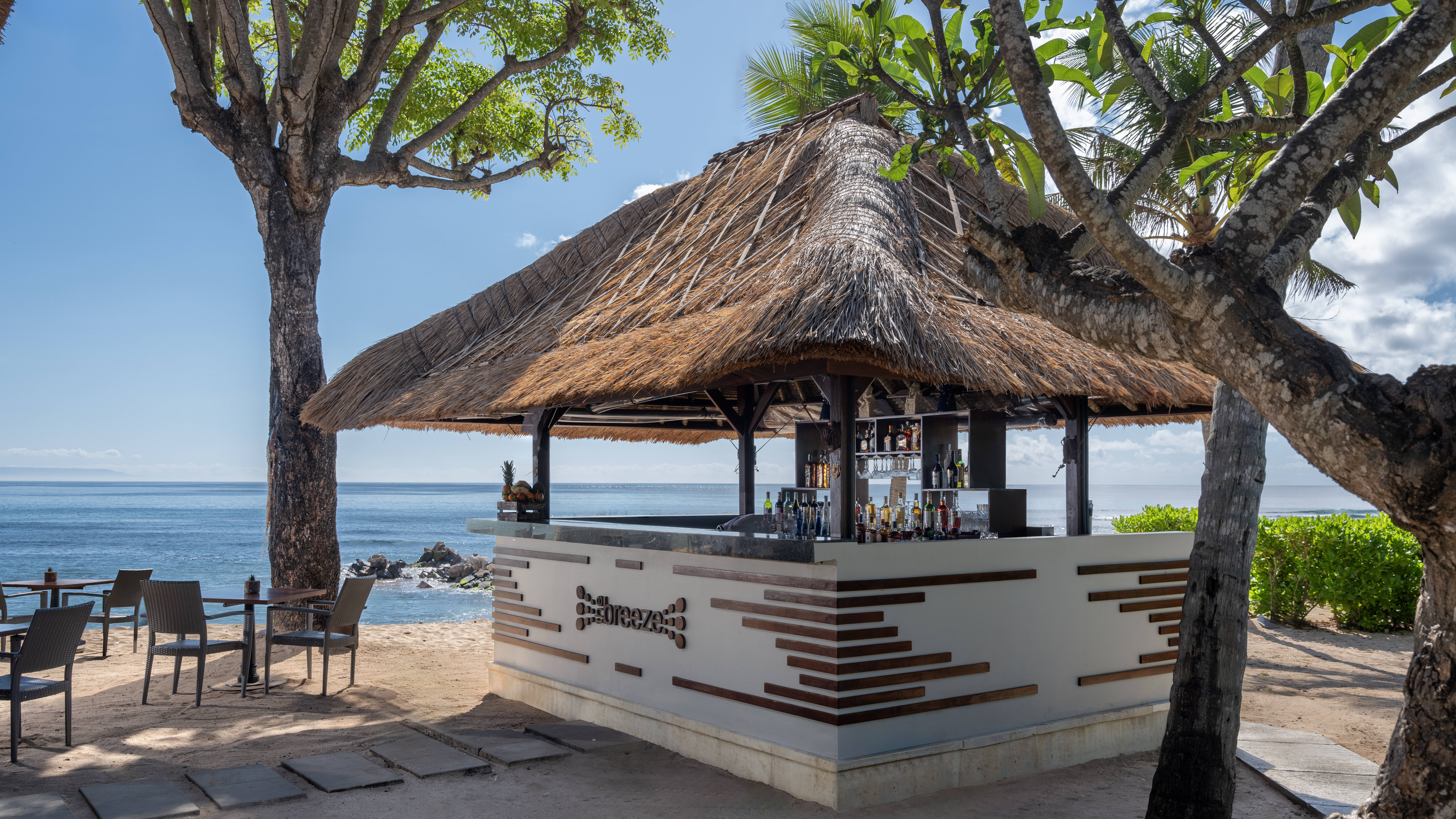 Outdoor bar area with thatched roof and seating