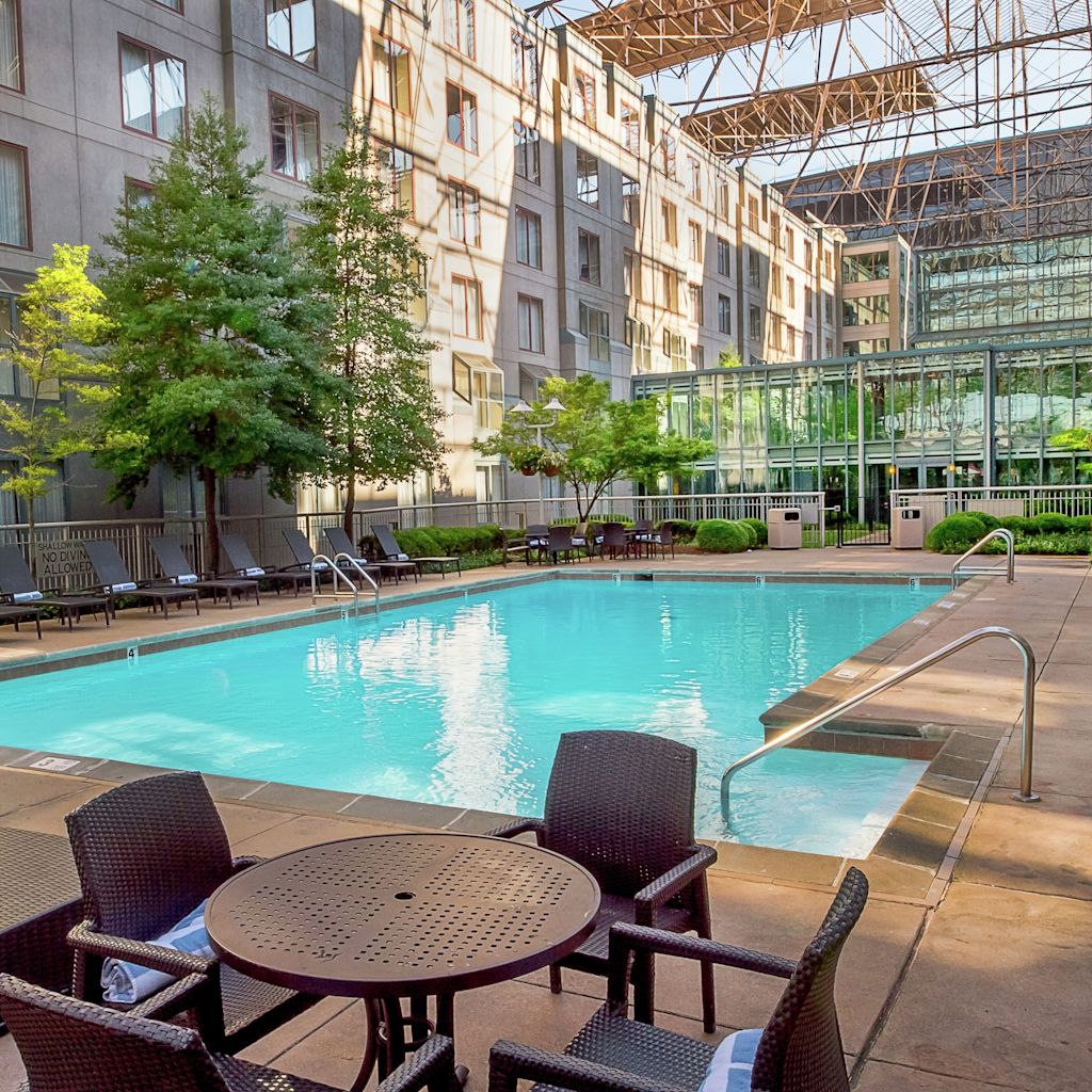 Outdoor Swimming Pool in Courtyard Area with Tables and Chairs