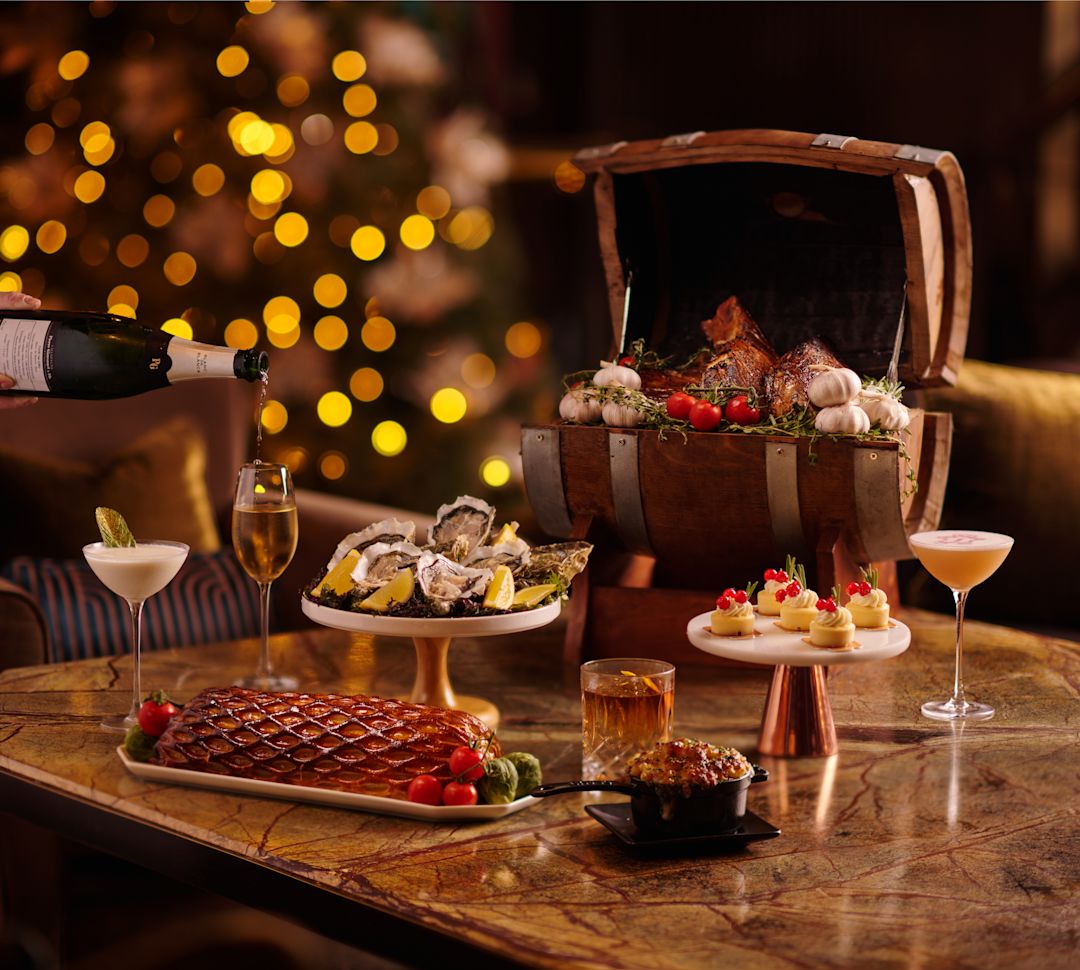 multiple plates of food next with christmas tree in background