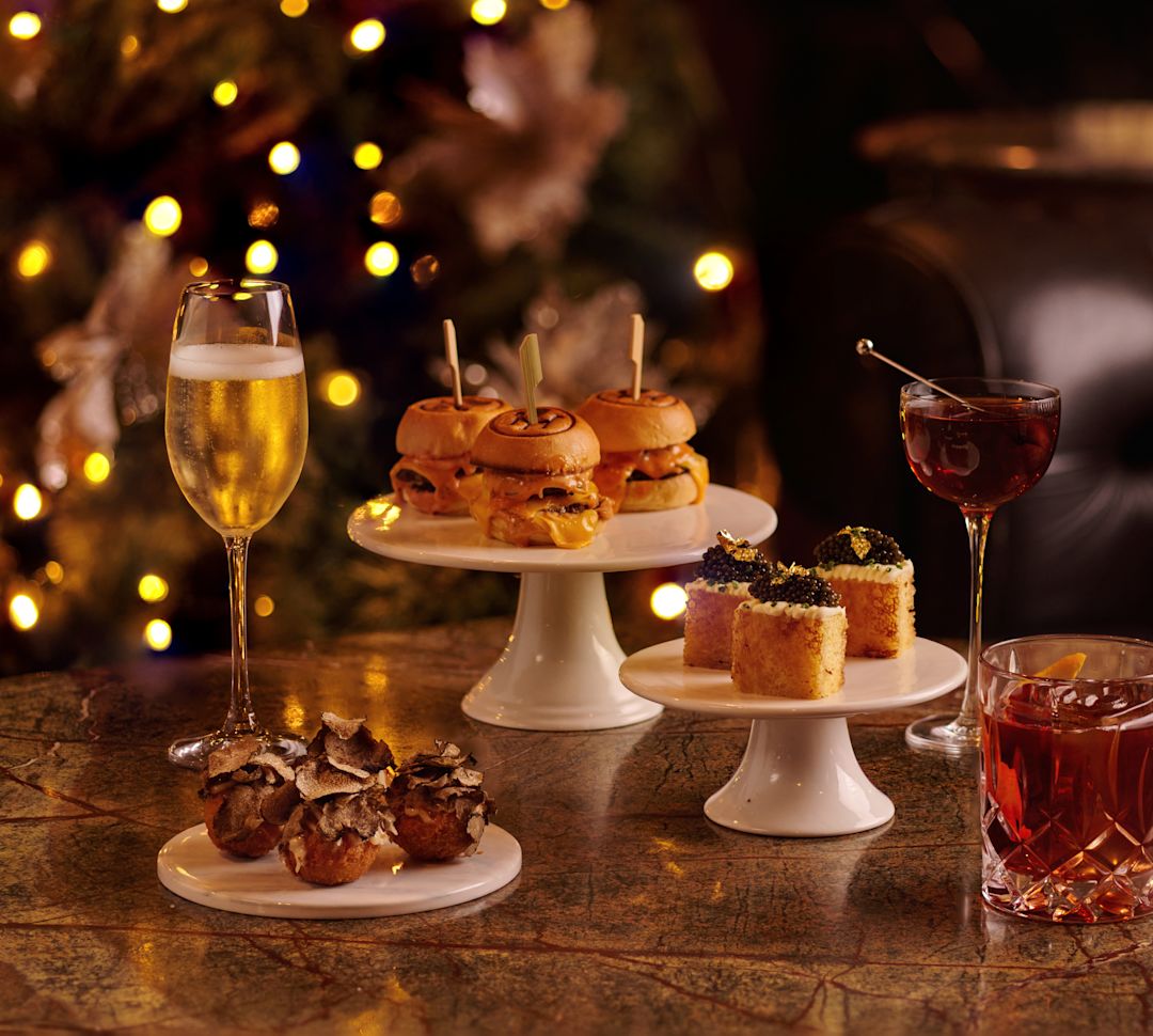 multiple plates of food next with christmas tree in background