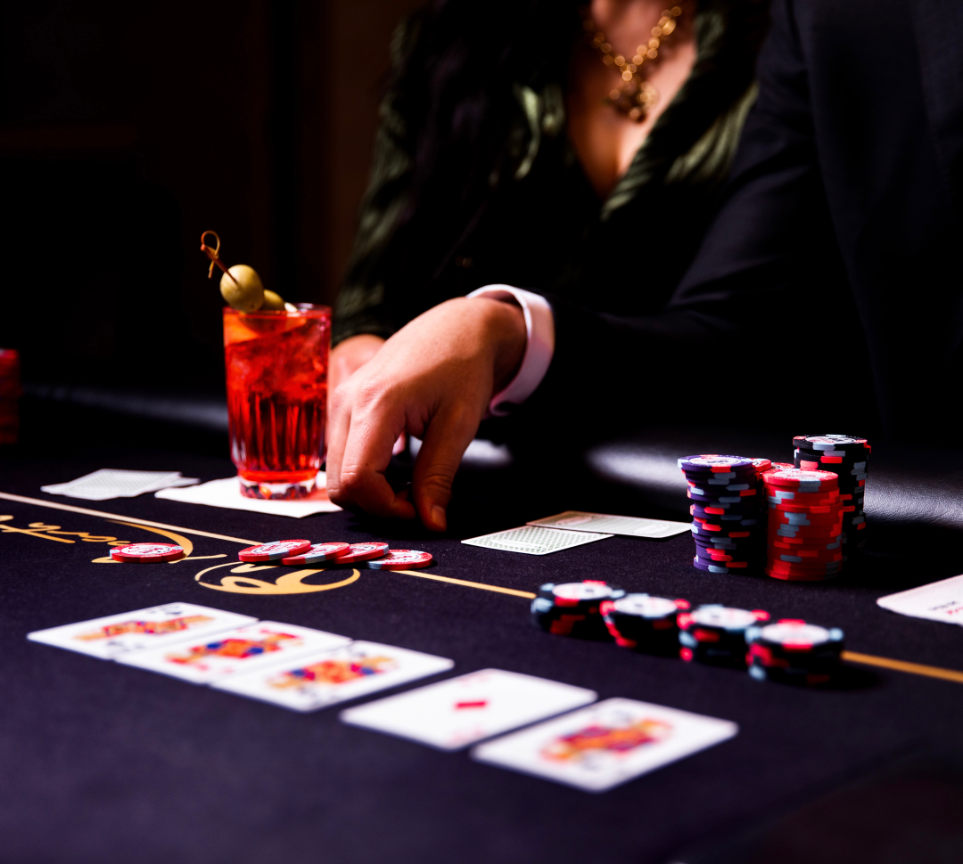 a Person Playing Cards at the Casino and Having Drinks