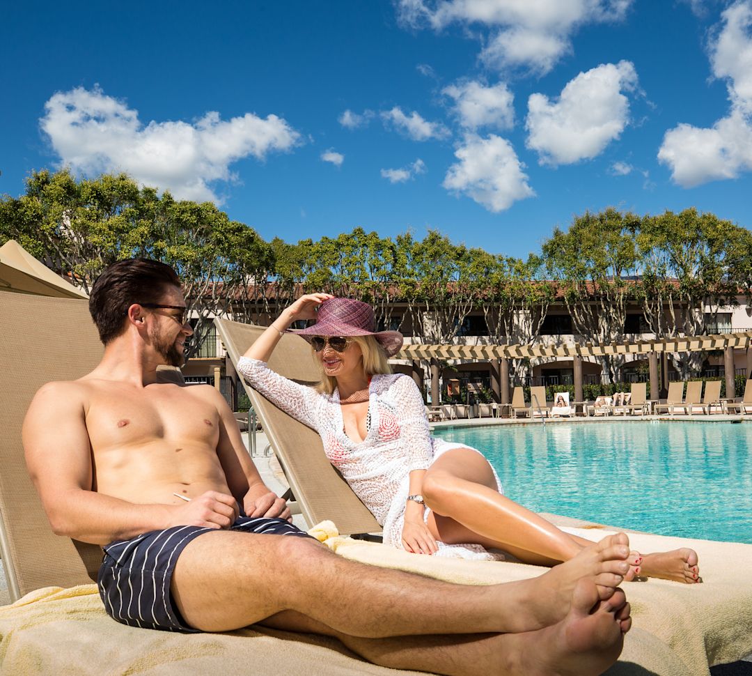 a couple enjoying the outdoor pool area