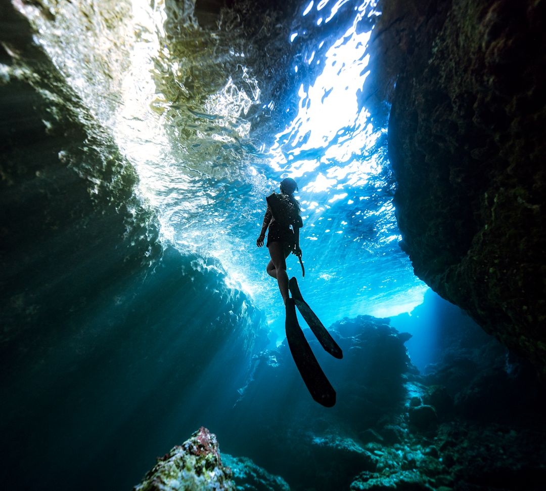 Woman diver swimming up to the surface
