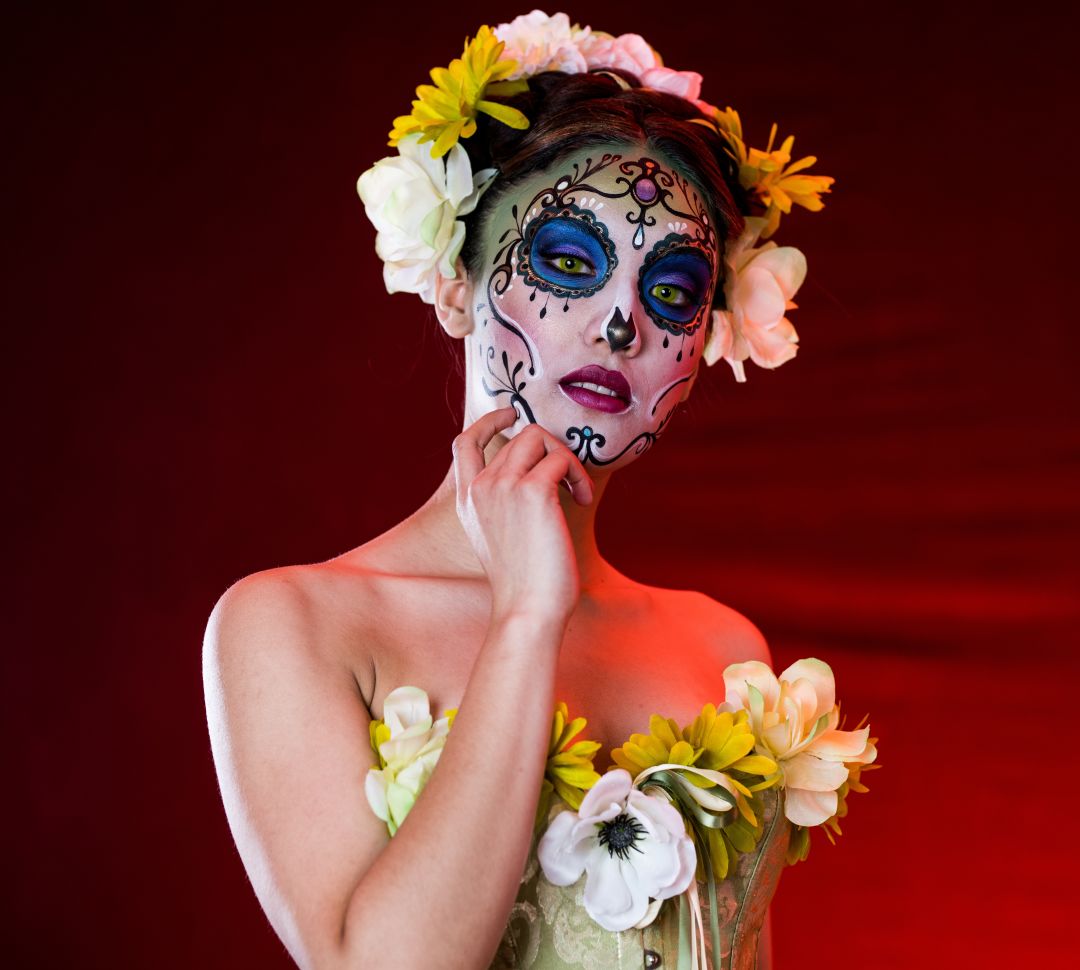 woman with dia de los muertos sugar skull painted on her face