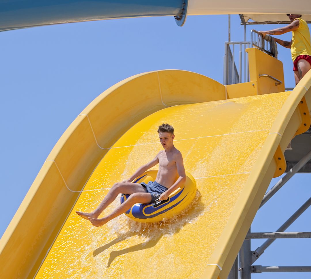 Teenager Sliding into a Pool of Water