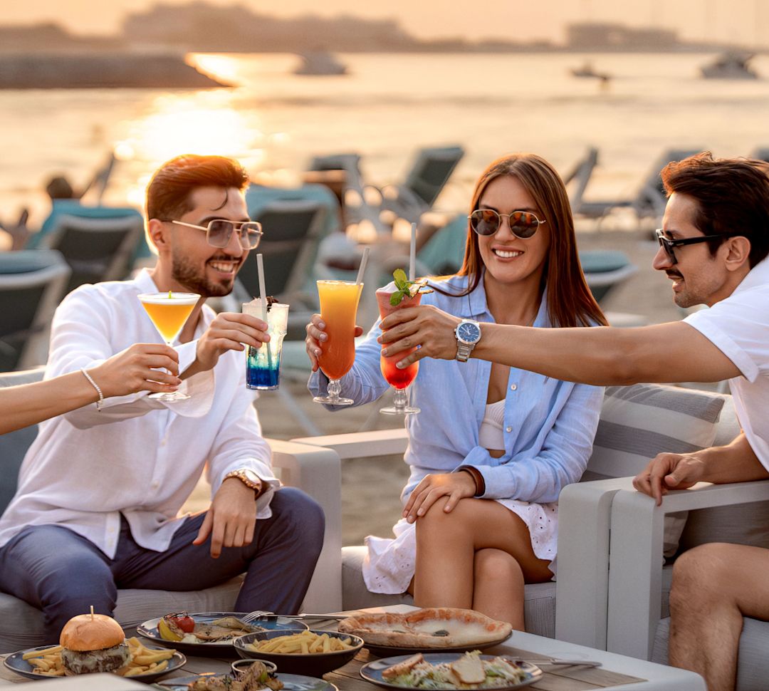 a Group of People Dining and Having Drinks on the Terrace of Zing Pool and Beach Bar
