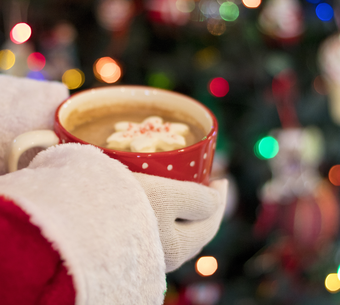 santa holding a cup of hot chocolate