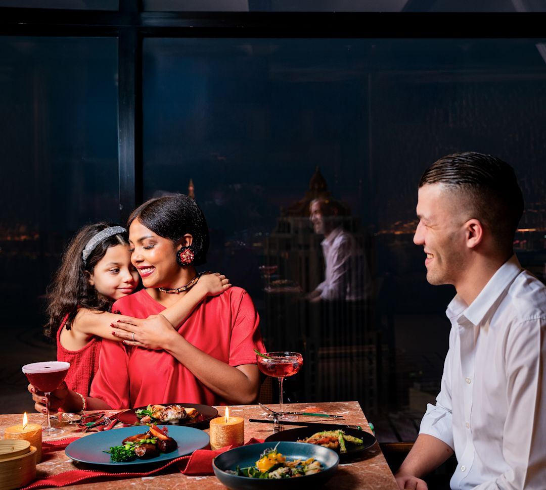 Yun restaurant, family at a dining table, daughter hugging her mother