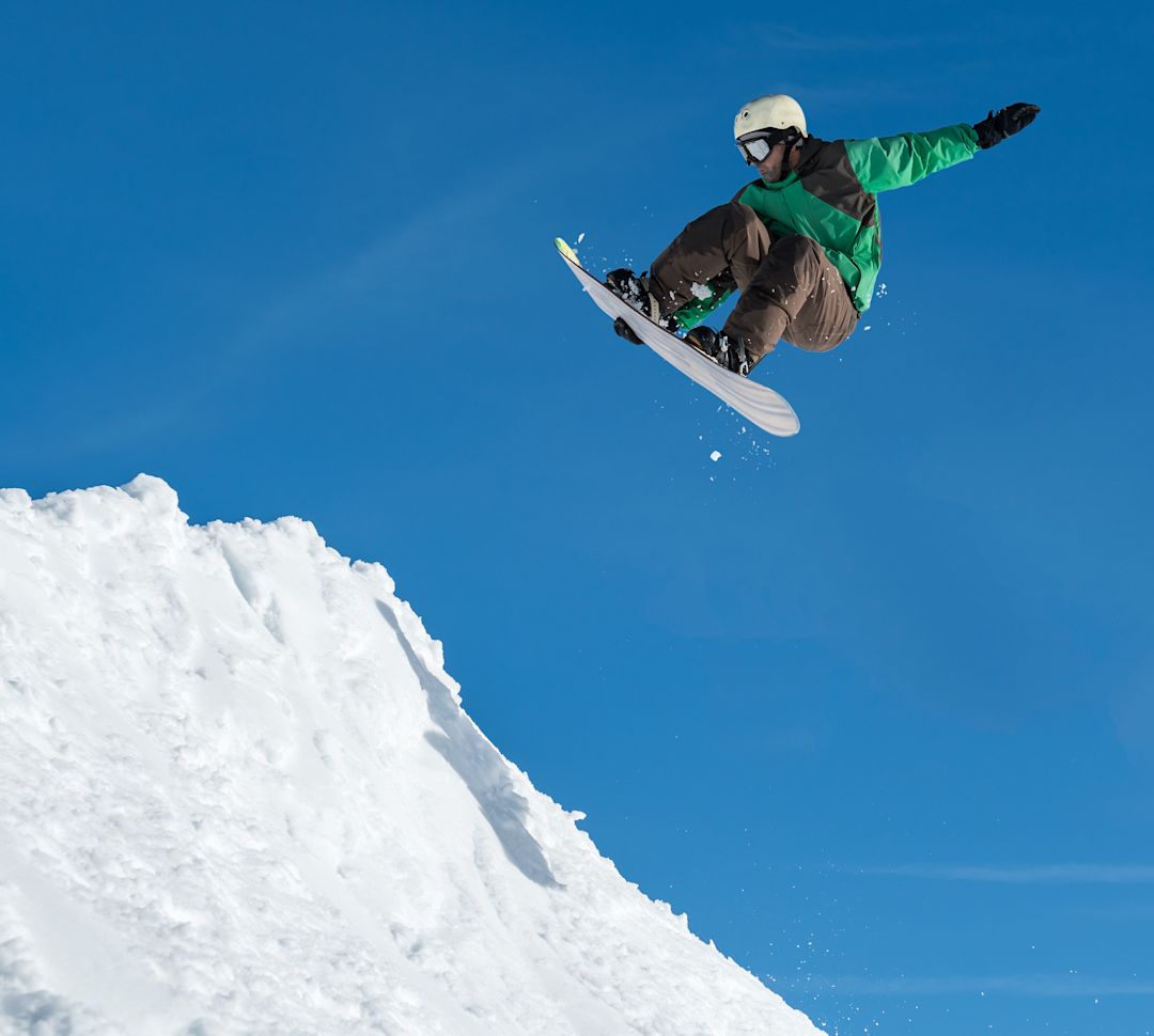 guy jumping on a snowboard