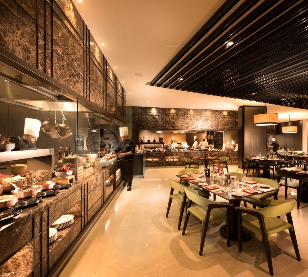 Chef at buffet with restaurant seating
