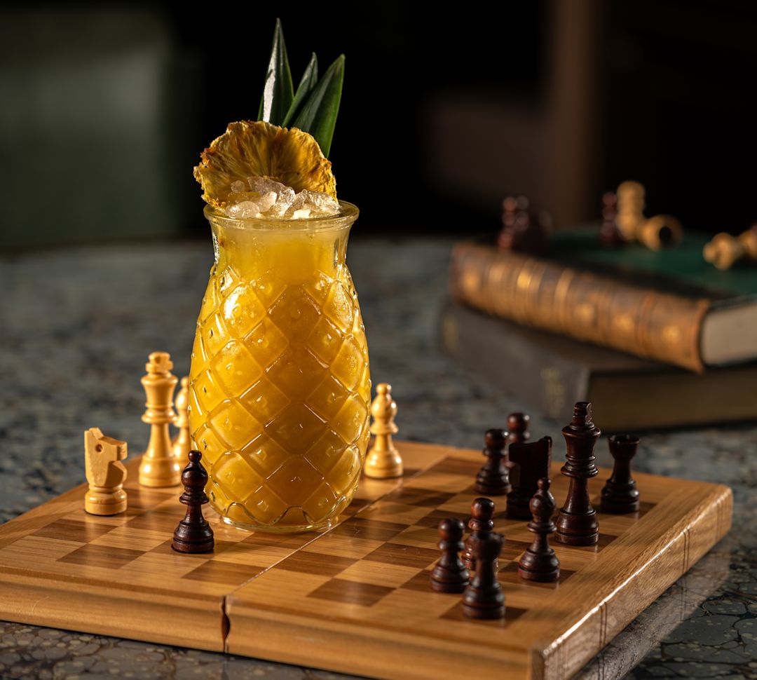 Bevanda di ananas su un tavolo e gioco di scacchi al Lemuels Bar