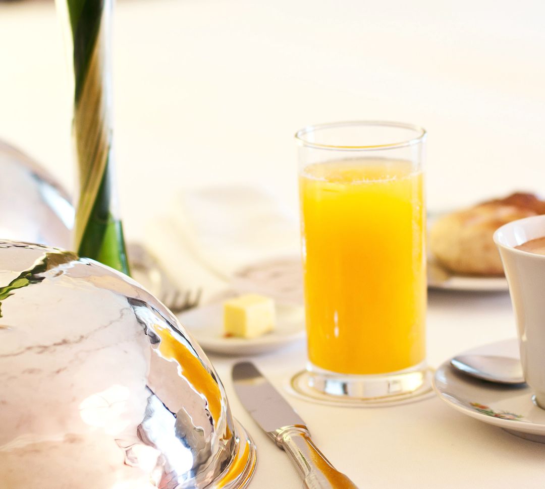 Close Up of Glass of Orange Juice on Dining Table
