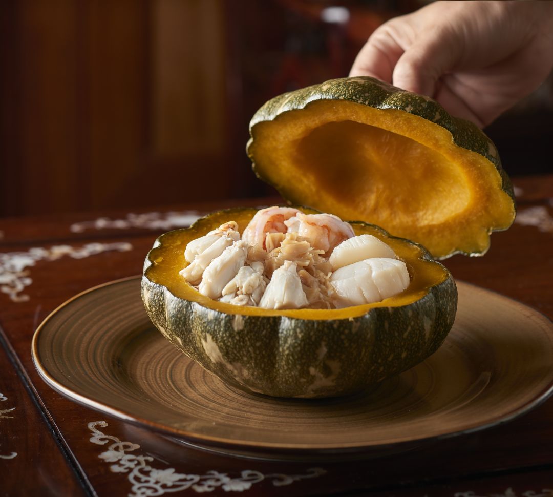 Crab meat and scallops inside a carved out melon