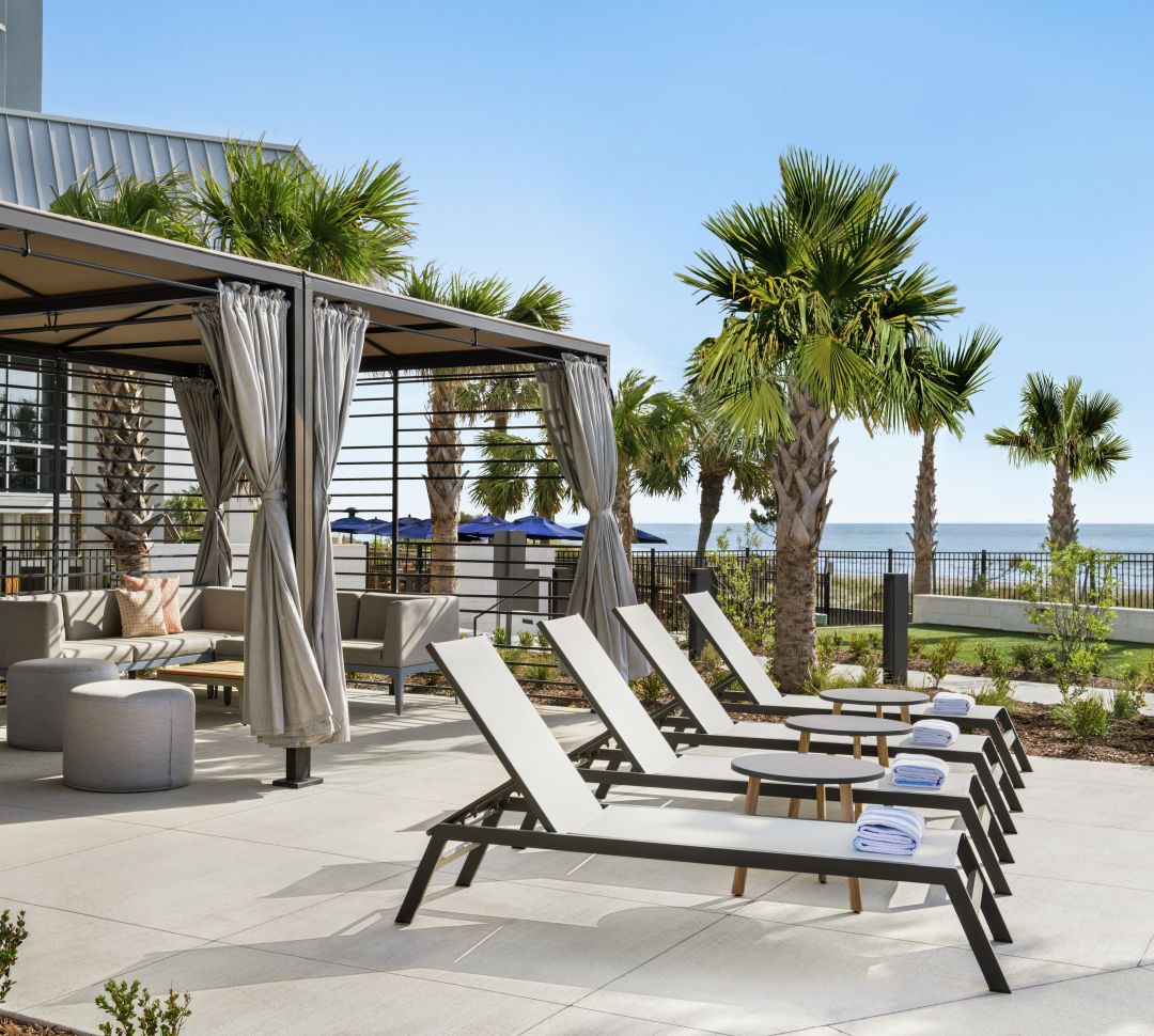 Stunning outdoor cabanas featuring ample seating and ocean view